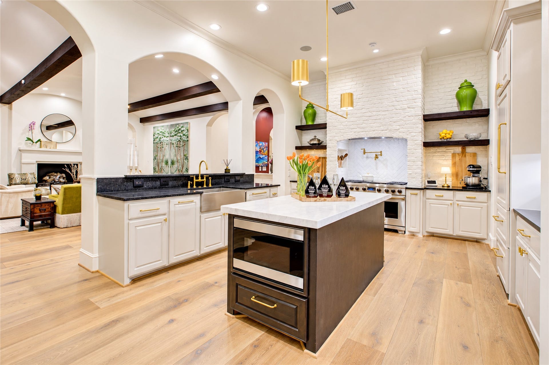 2215 North Boulevard, Houston, TX 77098 Elevated kitchen finishes include a herringbone brick cooking surround, soft-close cabinetry, and a Sharp microwave drawer in the island.