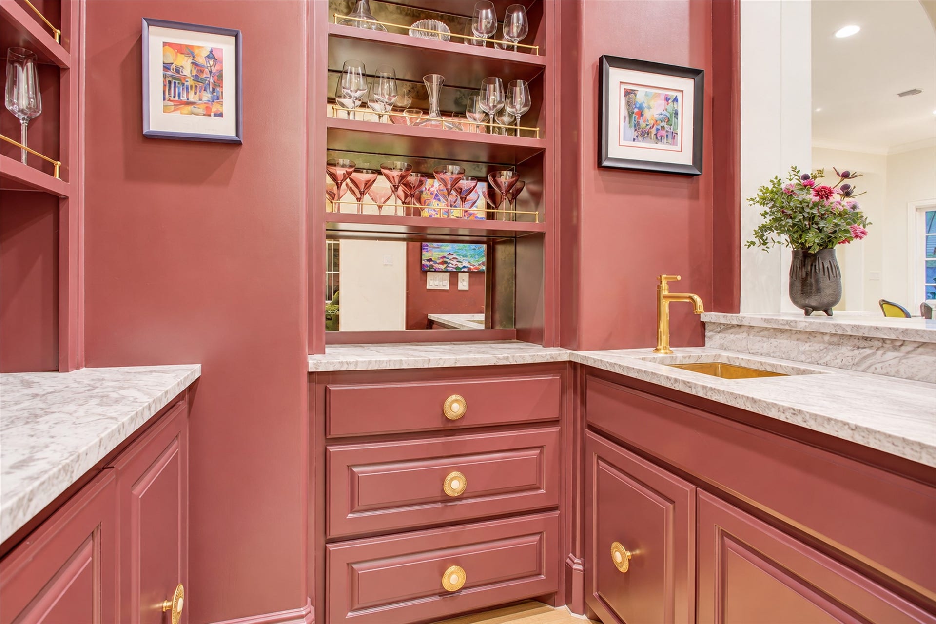 2215 North Boulevard, Houston, TX 77098 An arched alcove frames this refined wet bar, where deep merlot soft-close cabinetry adds depth and distinction.