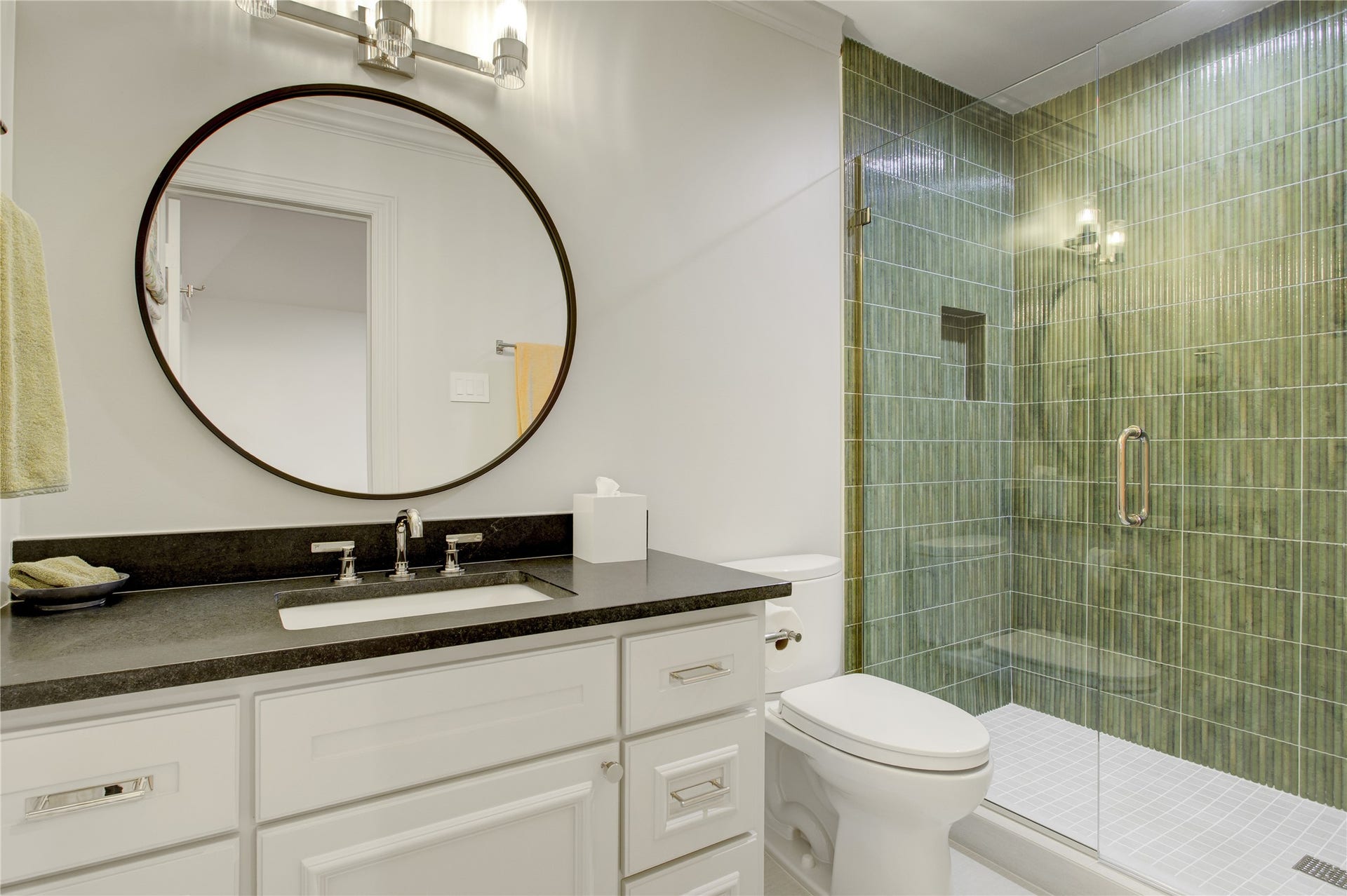 2215 North Boulevard, Houston, TX 77098 Textured emerald green tile makes a bold statement alongside honed black granite countertops and a spacious walk-in shower.