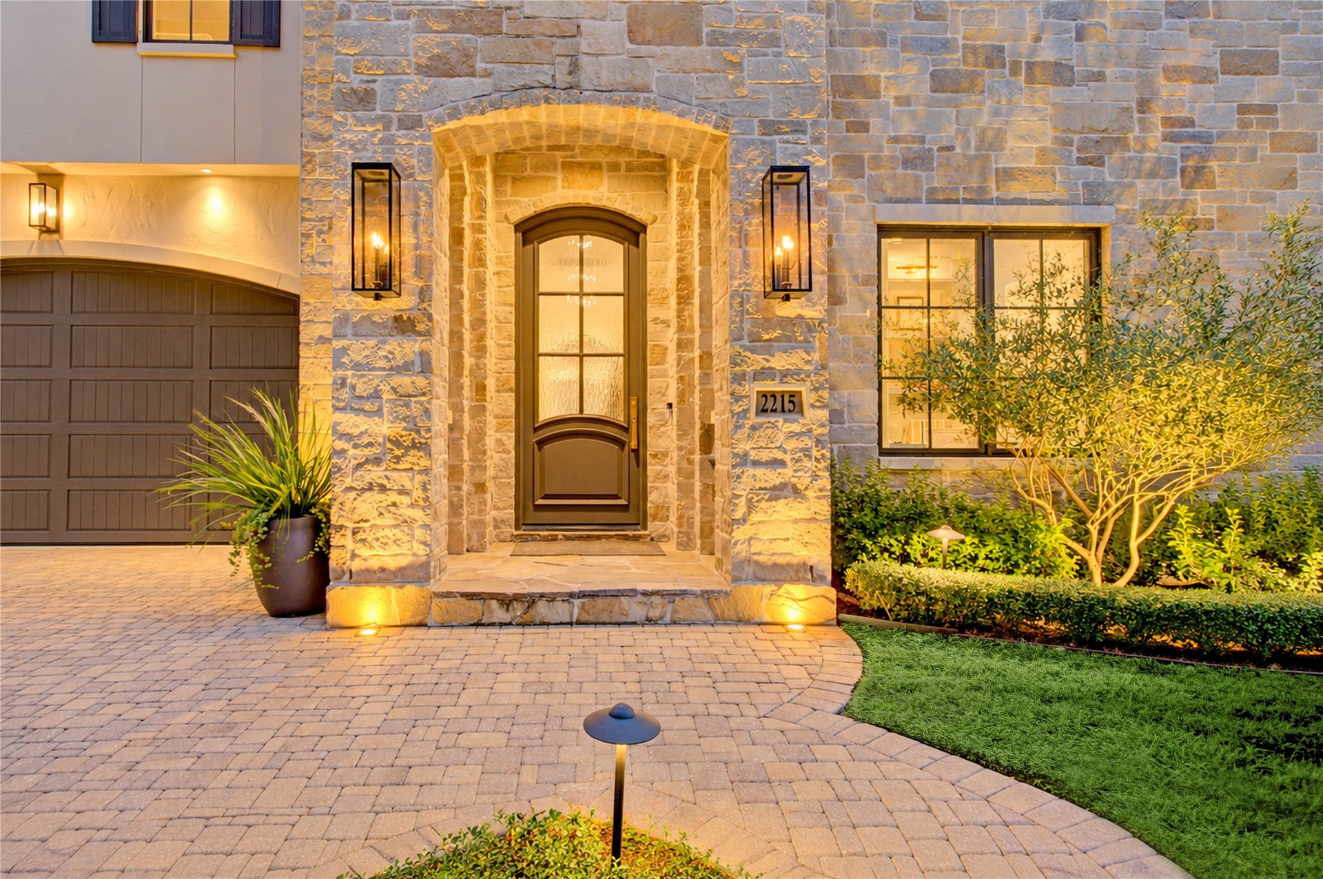 2215 North Boulevard, Houston, TX 77098 A covered stone entry welcomes guests through an eight-foot painted wood door with textured glass for added privacy.