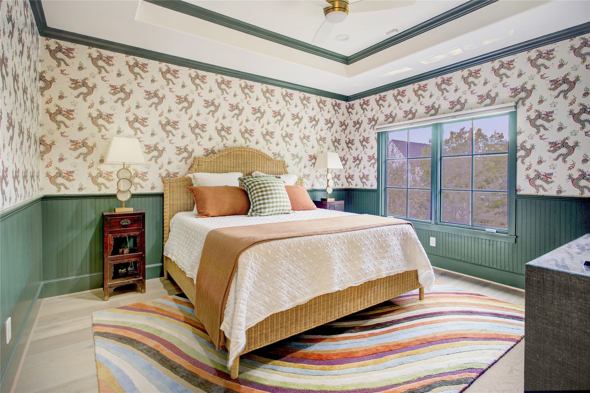 2215 North Boulevard, Houston, TX 77098 Designer dragon wallpaper and rich green millwork bring bold character to this secondary bedroom, finished with a 10-foot tray ceiling.