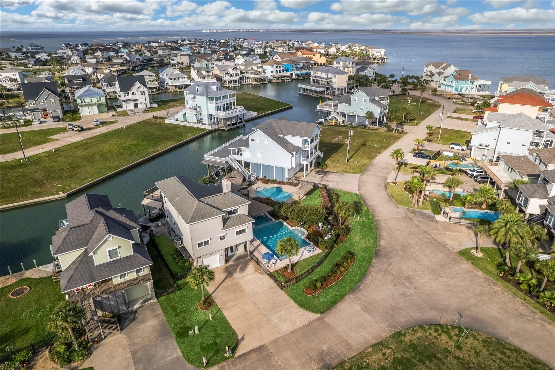 519 Westerly Drive, Tiki Island, TX 77554 Tiki Island features lush landscaping, private driveways, and backyard pools, offering scenic water views and easy access to the bay. Perfect for buyers seeking a waterfront lifestyle.
