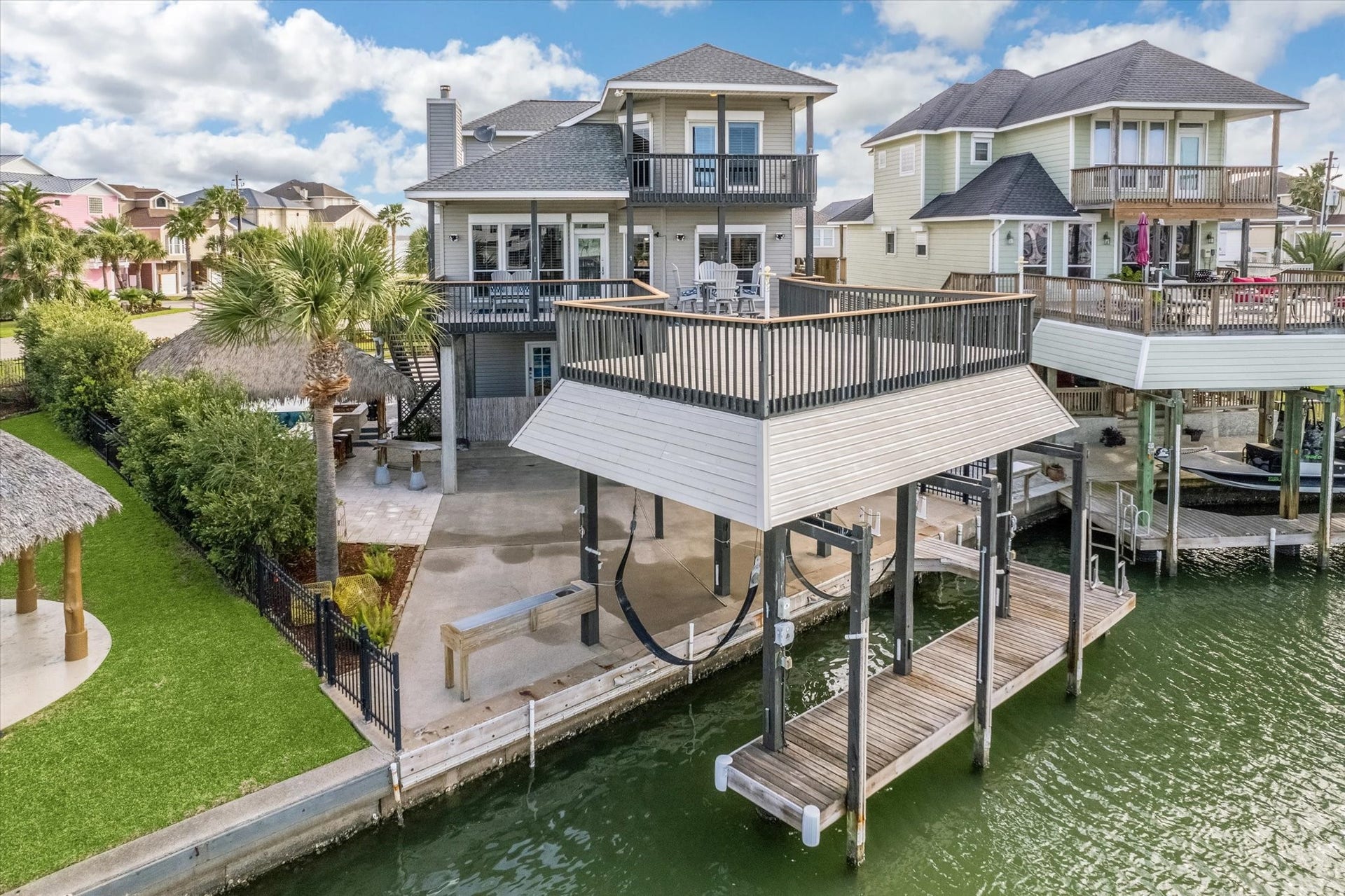 519 Westerly Drive, Tiki Island, TX 77554 This Tiki Island waterfront home features a spacious deck with stunning views, a boat lift, and a covered patio area. Its perfect for outdoor entertaining and enjoying the serene canal access.