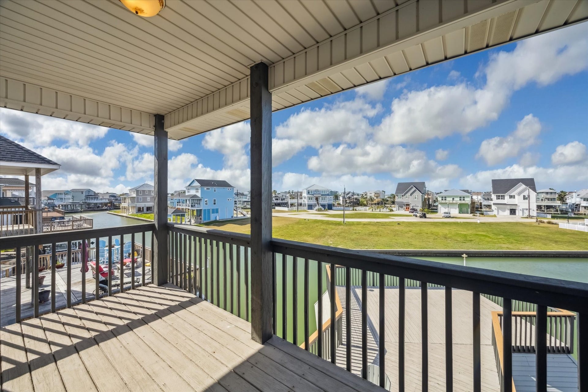 519 Westerly Drive, Tiki Island, TX 77554 Your covered porch offers scenic views of the waterfront community.