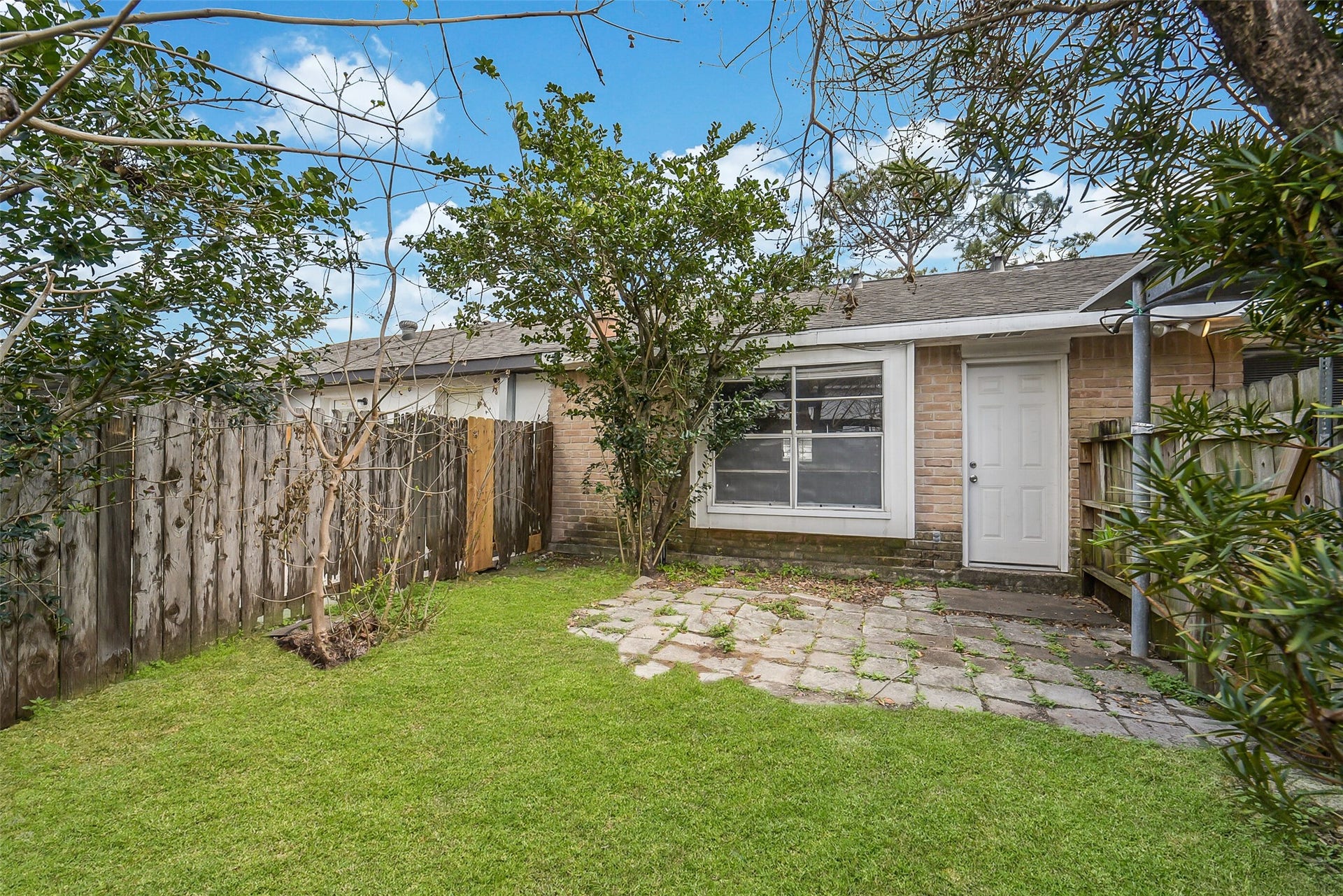 7265 Chasewood Drive, Houston, TX 77489 Step outside to a fully fenced backyard offering the perfect balance of privacy and low-maintenance outdoor living. A spacious paver patio provides plenty of room for grilling, outdoor dining, or relaxing beneath the shade of mature trees and established landscaping.