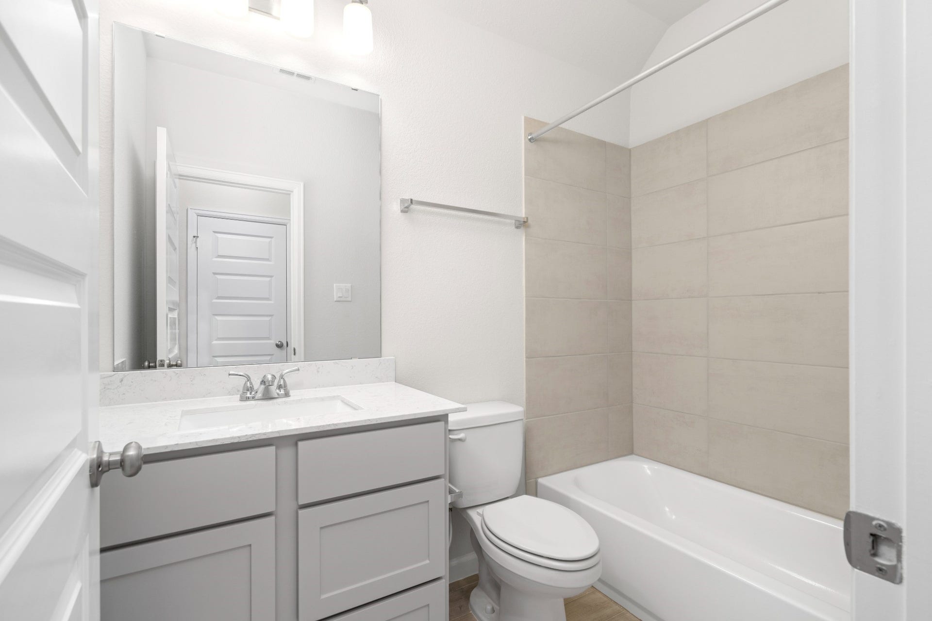 16955 Chapel Knox Drive, Humble, TX 77346 Secondary full bathroom with modern vanity, quartz-style countertop and tiled tub/shower surround.