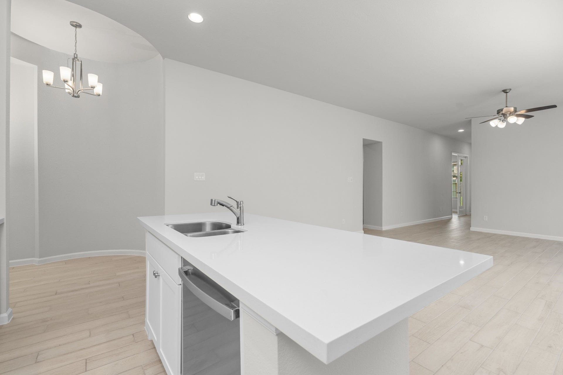16955 Chapel Knox Drive, Humble, TX 77346 Large kitchen island overlooking the dining and living areas in this open-concept home.