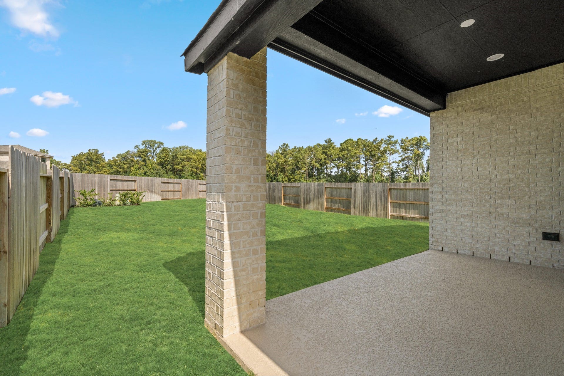 16955 Chapel Knox Drive, Humble, TX 77346 Covered back patio overlooking the large fenced yard, ideal for shaded outdoor living.