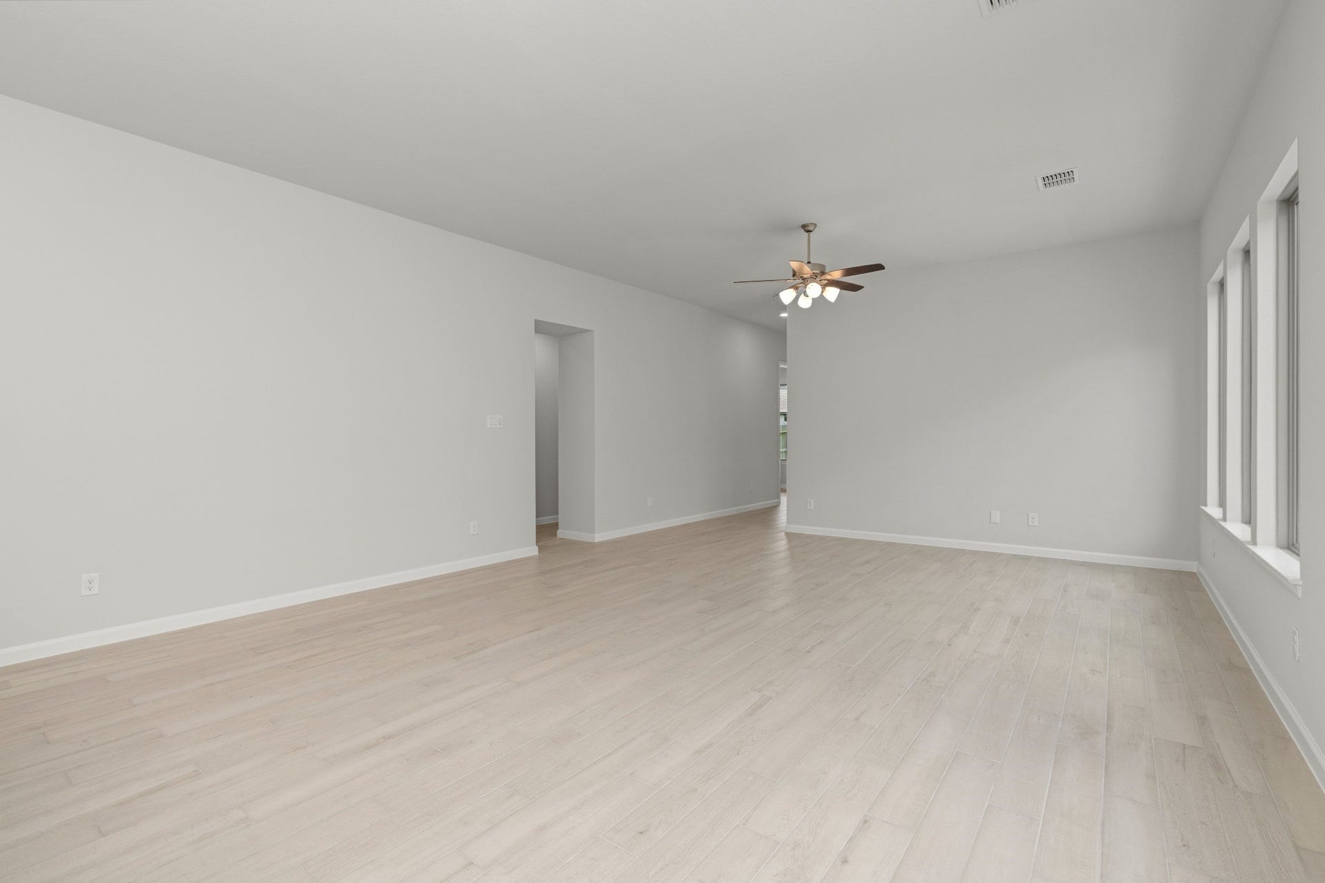 16955 Chapel Knox Drive, Humble, TX 77346 Spacious living room with high ceiling, ceiling fan and neutral finishes.