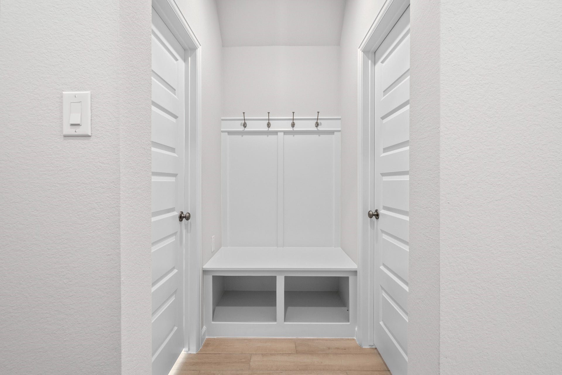 16955 Chapel Knox Drive, Humble, TX 77346 Built-in mudroom-style drop zone with bench, hooks and storage near the home's everyday entry.