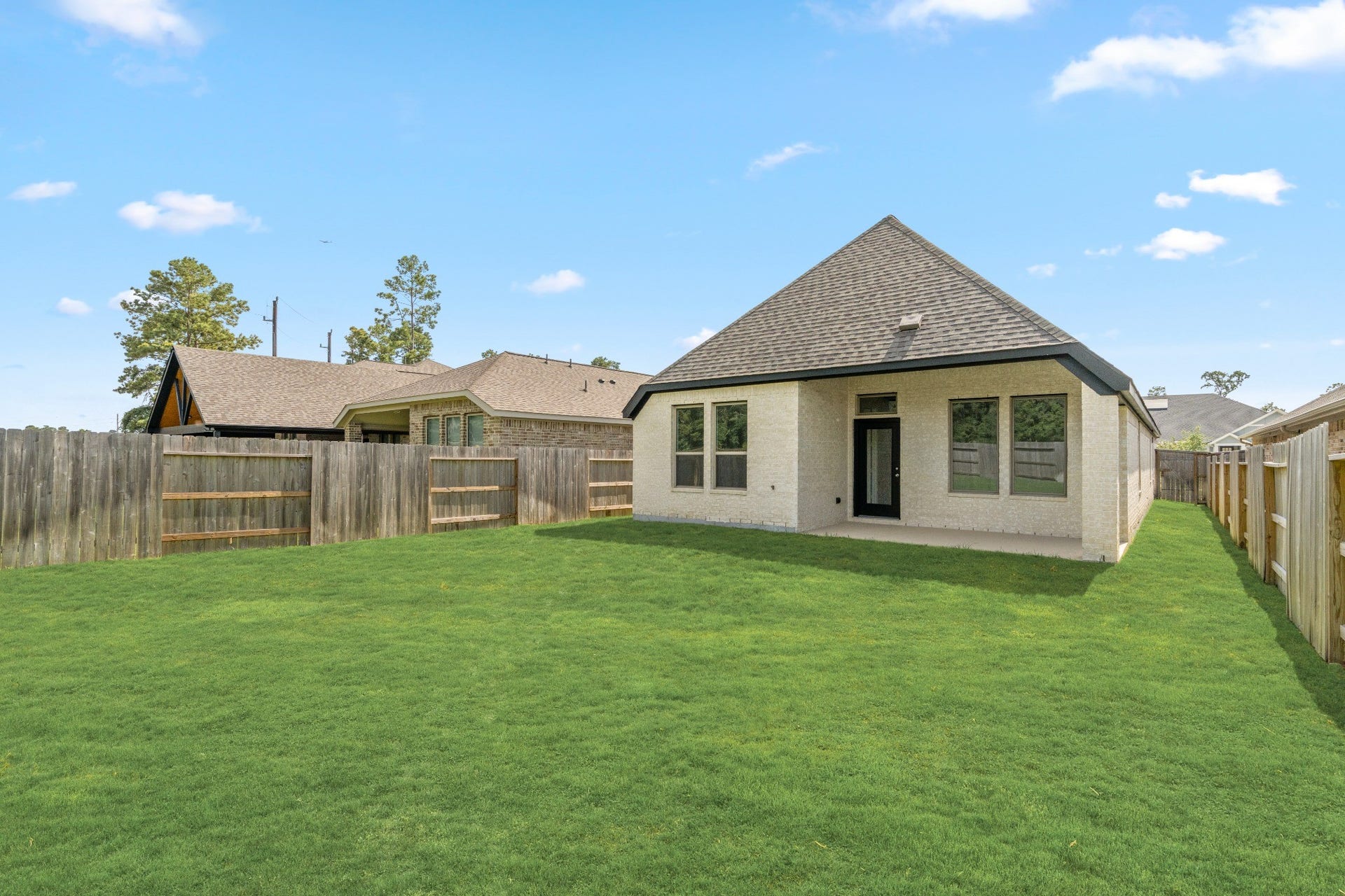 16955 Chapel Knox Drive, Humble, TX 77346 Spacious fenced backyard with green lawn and no immediate rear home directly behind the property.