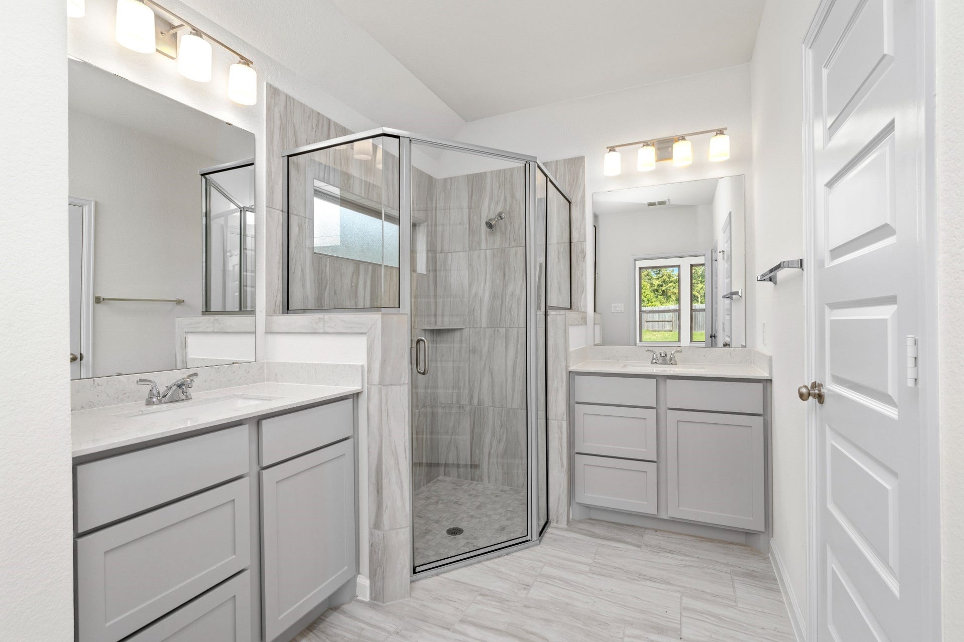 16955 Chapel Knox Drive, Humble, TX 77346 Primary bathroom with dual vanities and oversized glass-enclosed tiled shower.