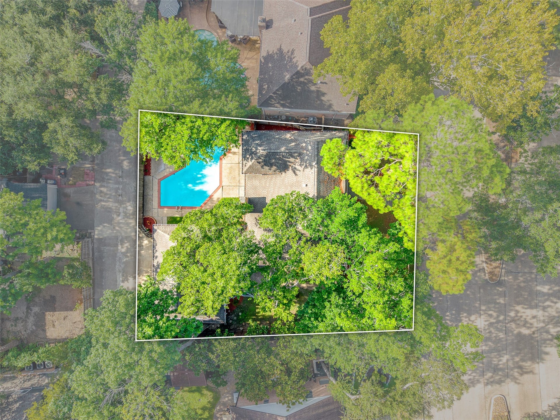 Charming property nestled among lush trees, featuring a spacious backyard with a sparkling pool, perfect for relaxation and outdoor enjoyment.