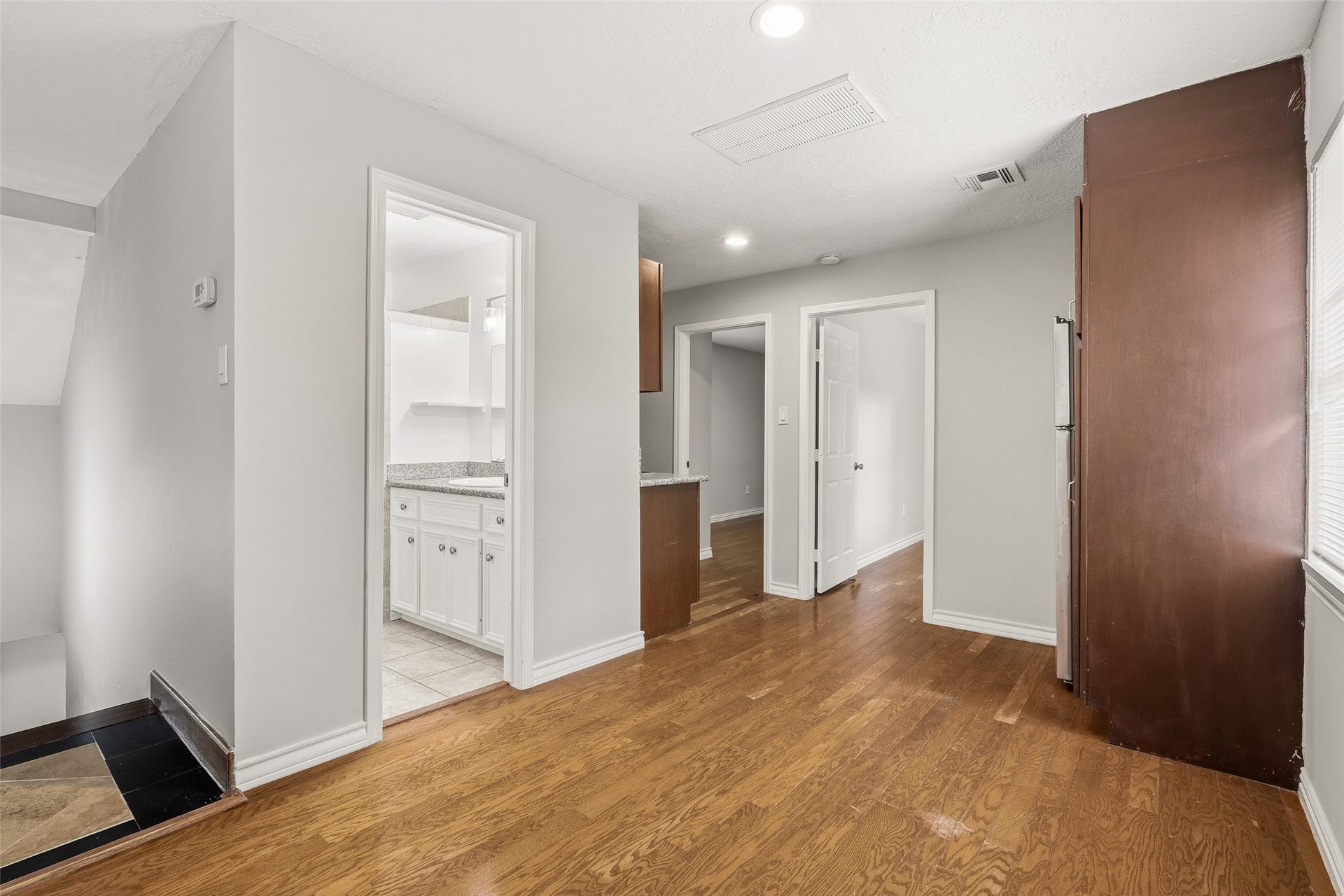 Bright and inviting space with modern recessed lighting, and convenient access to the kitchen and adjacent rooms.