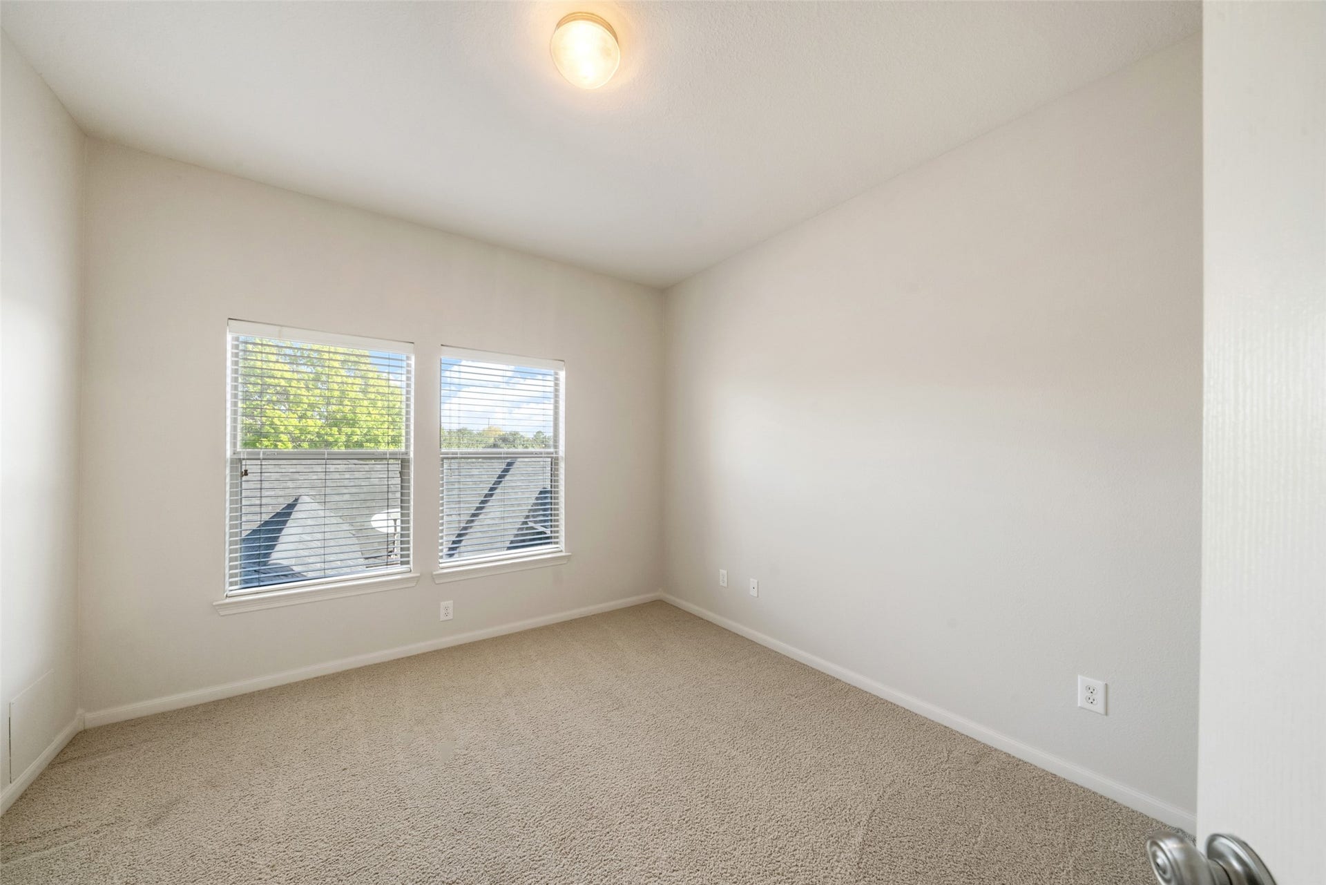 Bedroom number three is just off of the game room and has views of the backyard patio.