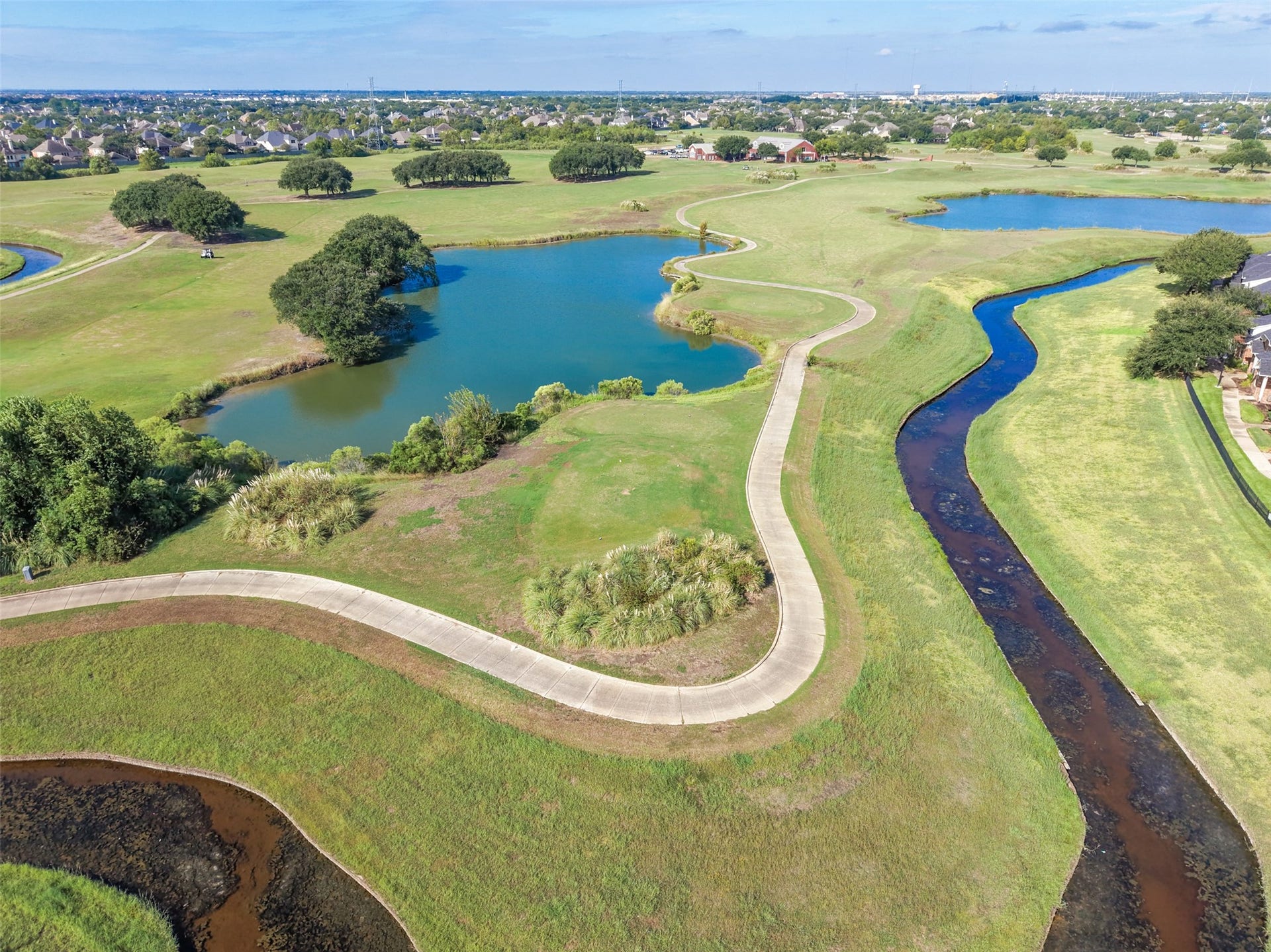 A birds eye view of the bend on the golf course where this home is located.