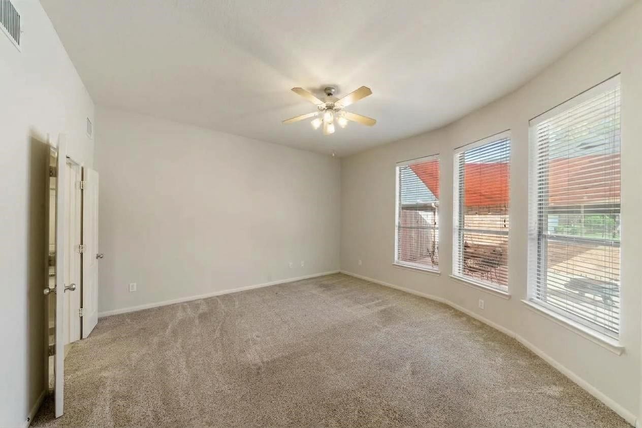 Oversized primary bedroom with plenty of space for your King-sized furniture and possible additional seating.  This room has a great view of the backyard patio.