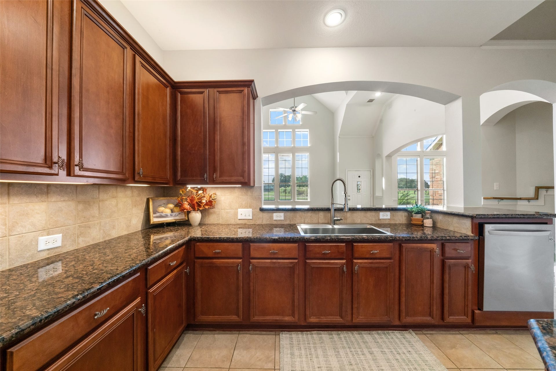 Lovely dark granite countertops with stainless steel appliances.  Lots of countertop and cabinet space in this home!