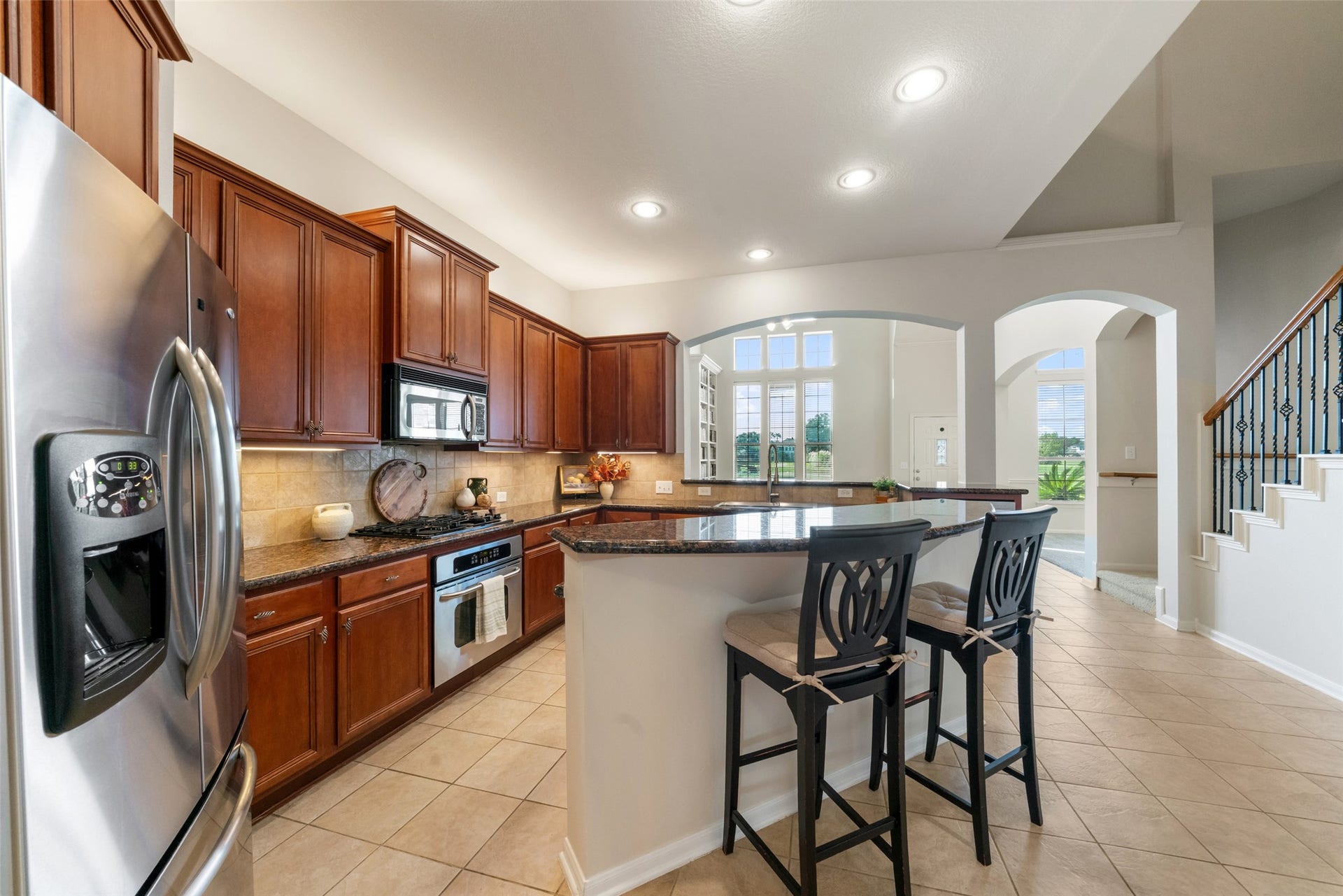 Kitchen Island has bar height seating.  Love the recessed lighting and undercabinet lighting in this kitchen.