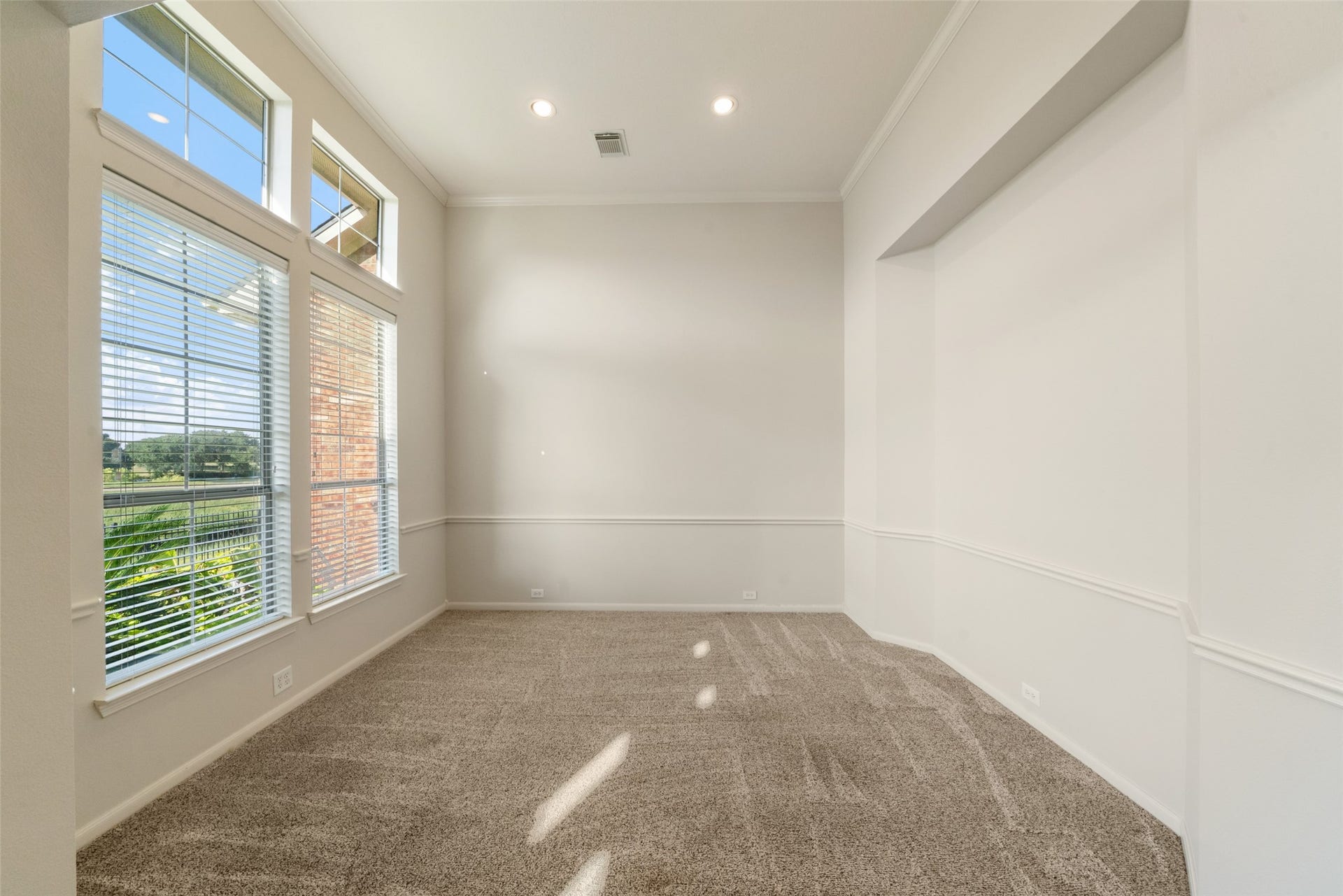 Dining room has recessed lighting and an architectural niche for your dining buffet table and artwork.