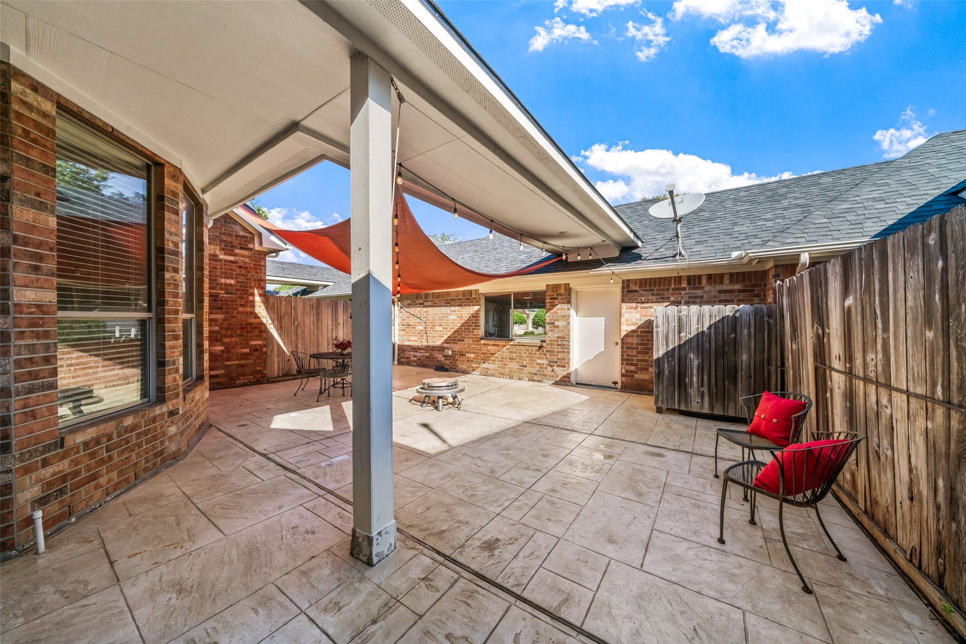 Another view of this backyard patio that leads to the three car garage.