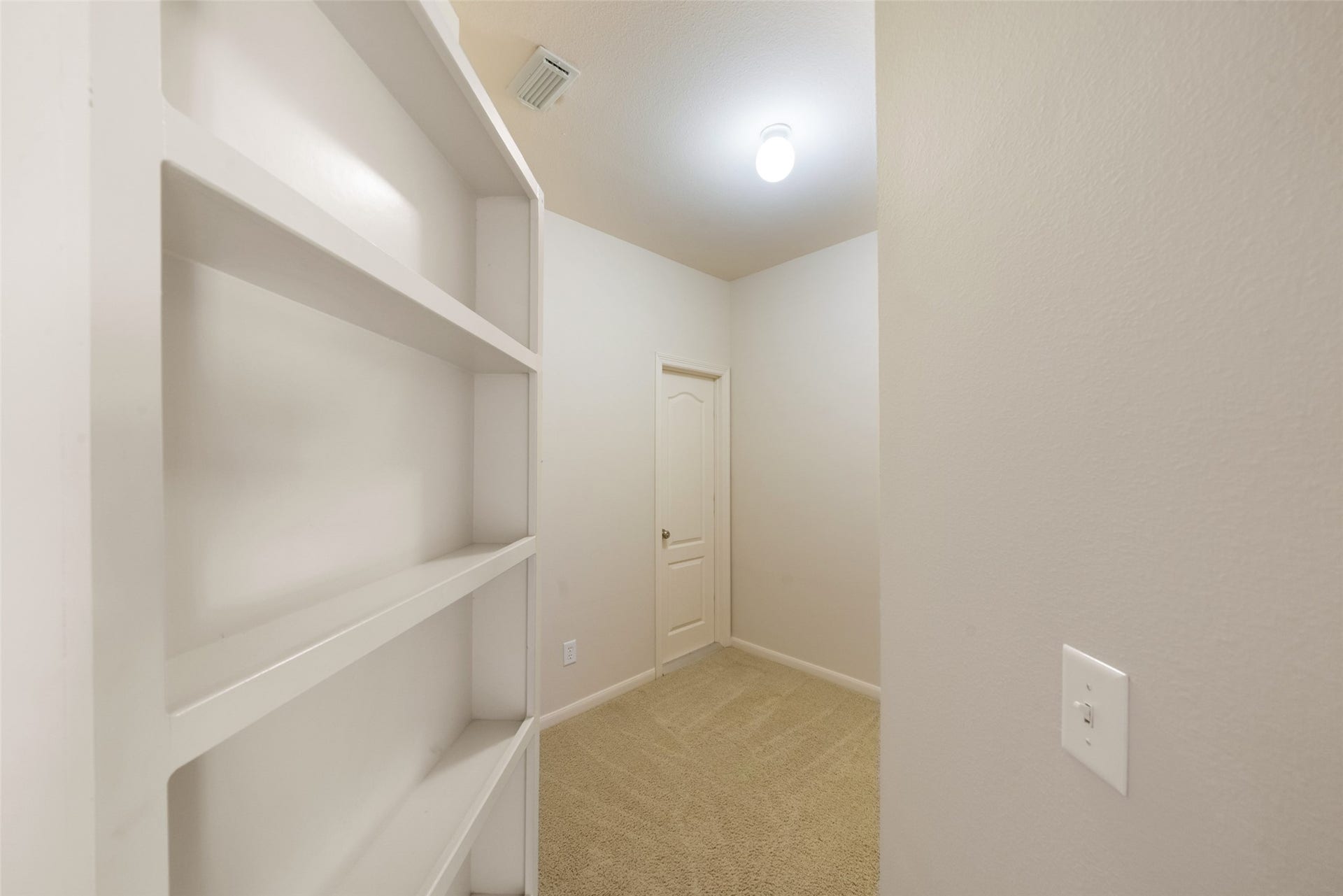 Bonus room could be used as a home office, home gym, craft or hobby room, or a climate-controlled storage room. The door in the back of the room leads to a walk-in attic. Attic is spacious and allows for easy home maintenance with additional storage space for holiday decor.