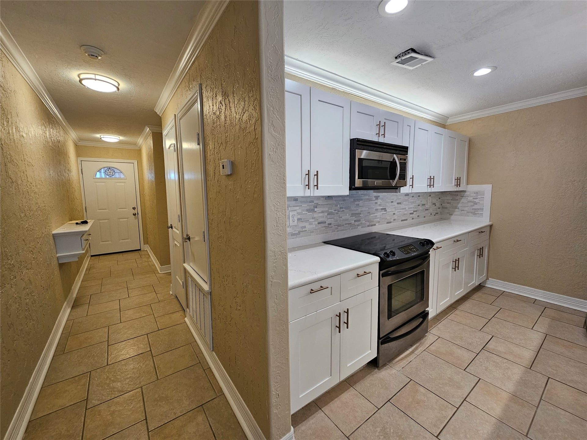 15575 Marina Drive, #323A, Conroe, TX 77356 Views down the hallway from the kitchen. Tile flooring throughout the main areas.