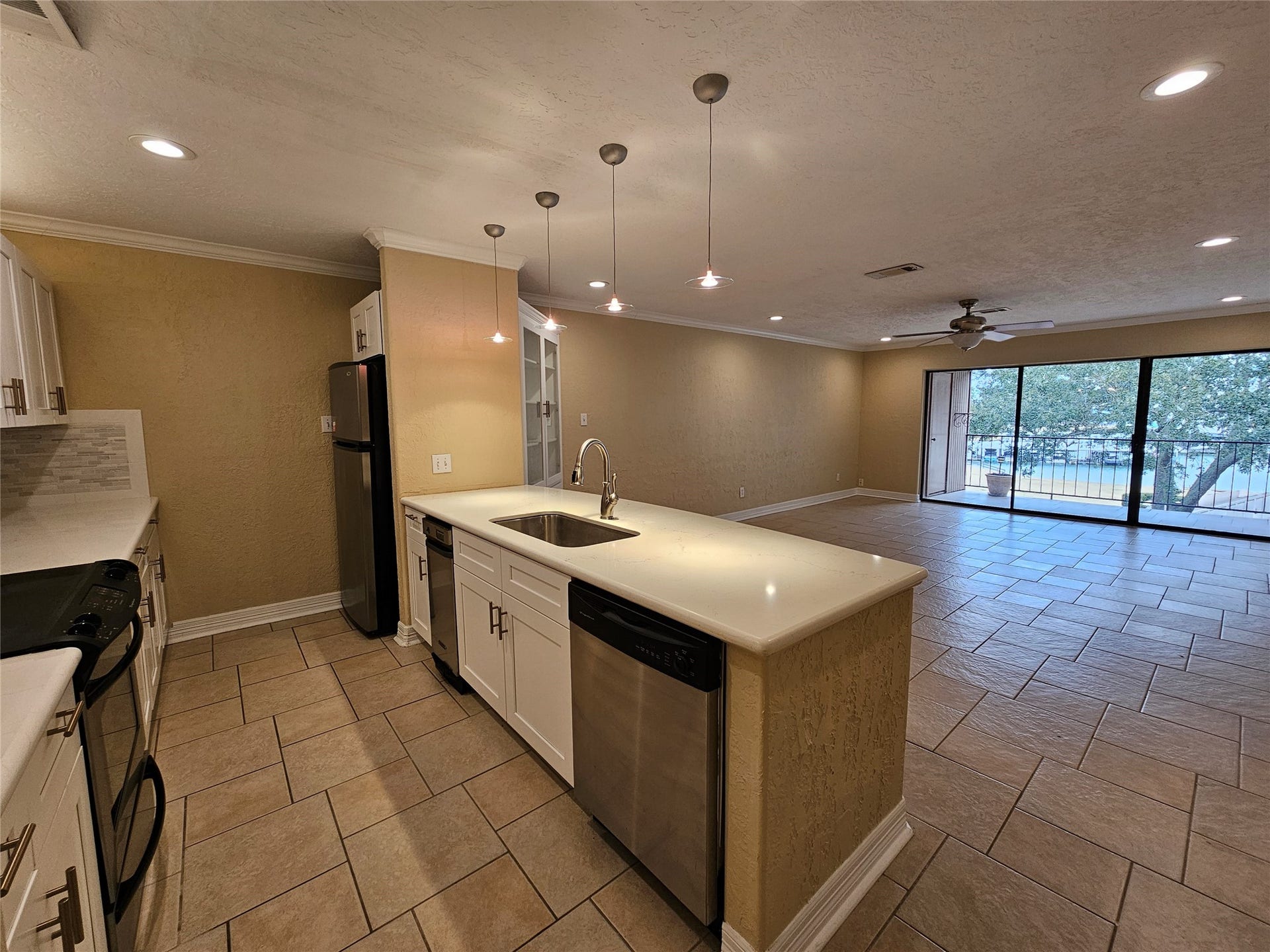 15575 Marina Drive, #323A, Conroe, TX 77356 The kitchen has been updated with stainless appliances, stove, trash compactor and fridge.