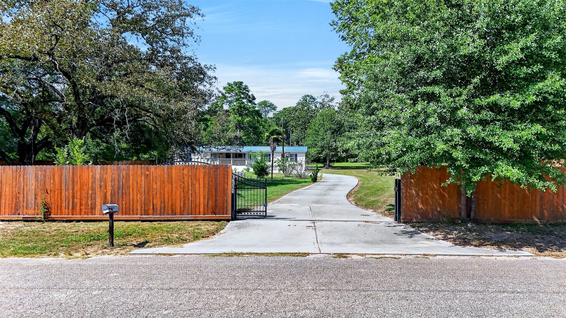 2581 Mann Road, Conroe, TX 77303 Gated driveway provides added privacy and access to the property.