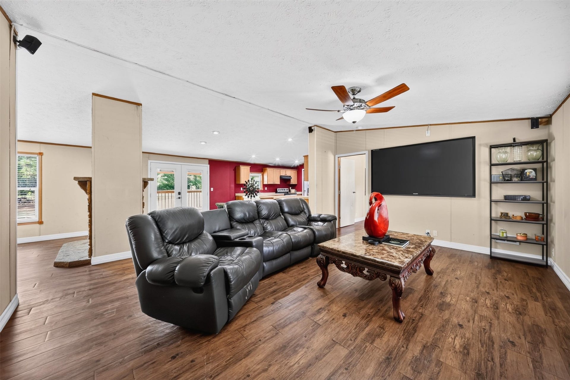 2581 Mann Road, Conroe, TX 77303 Bright living space with wood-look flooring, ceiling fan, and natural light.