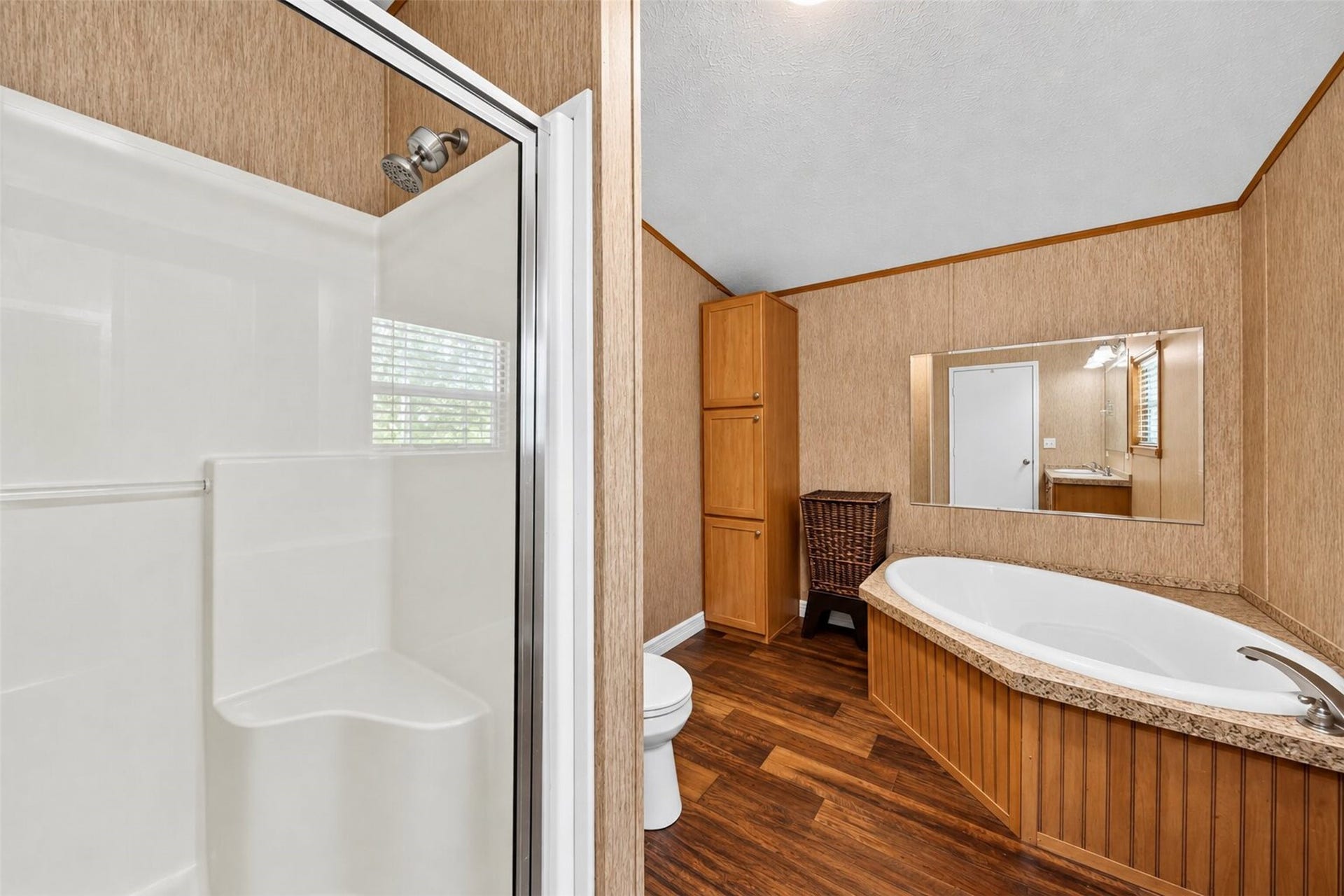 2581 Mann Road, Conroe, TX 77303 Full bathroom featuring a tub/shower combination, vanity, and warm wood cabinetry.