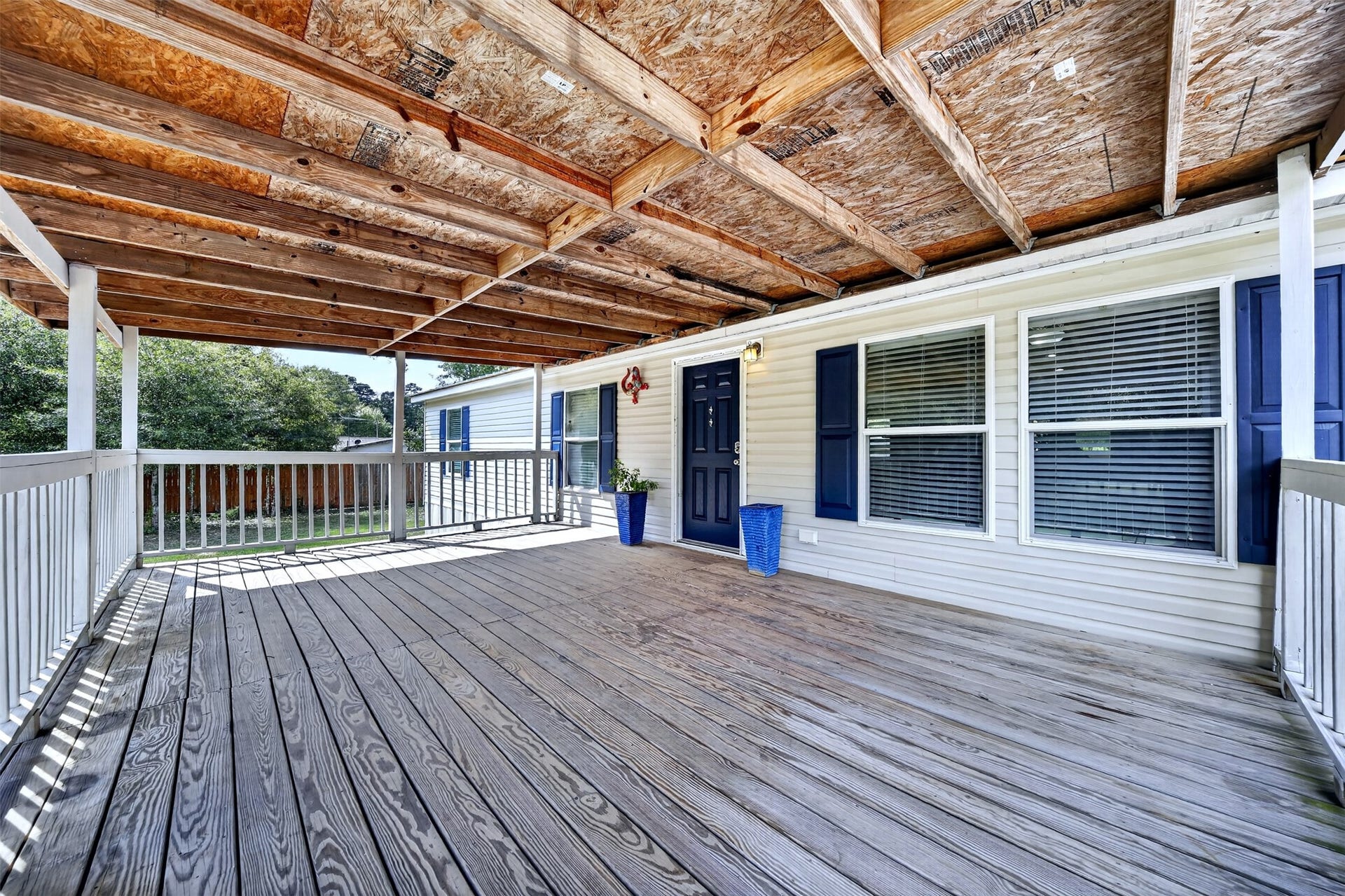 2581 Mann Road, Conroe, TX 77303 Spacious covered deck provides a shaded outdoor area overlooking the property.