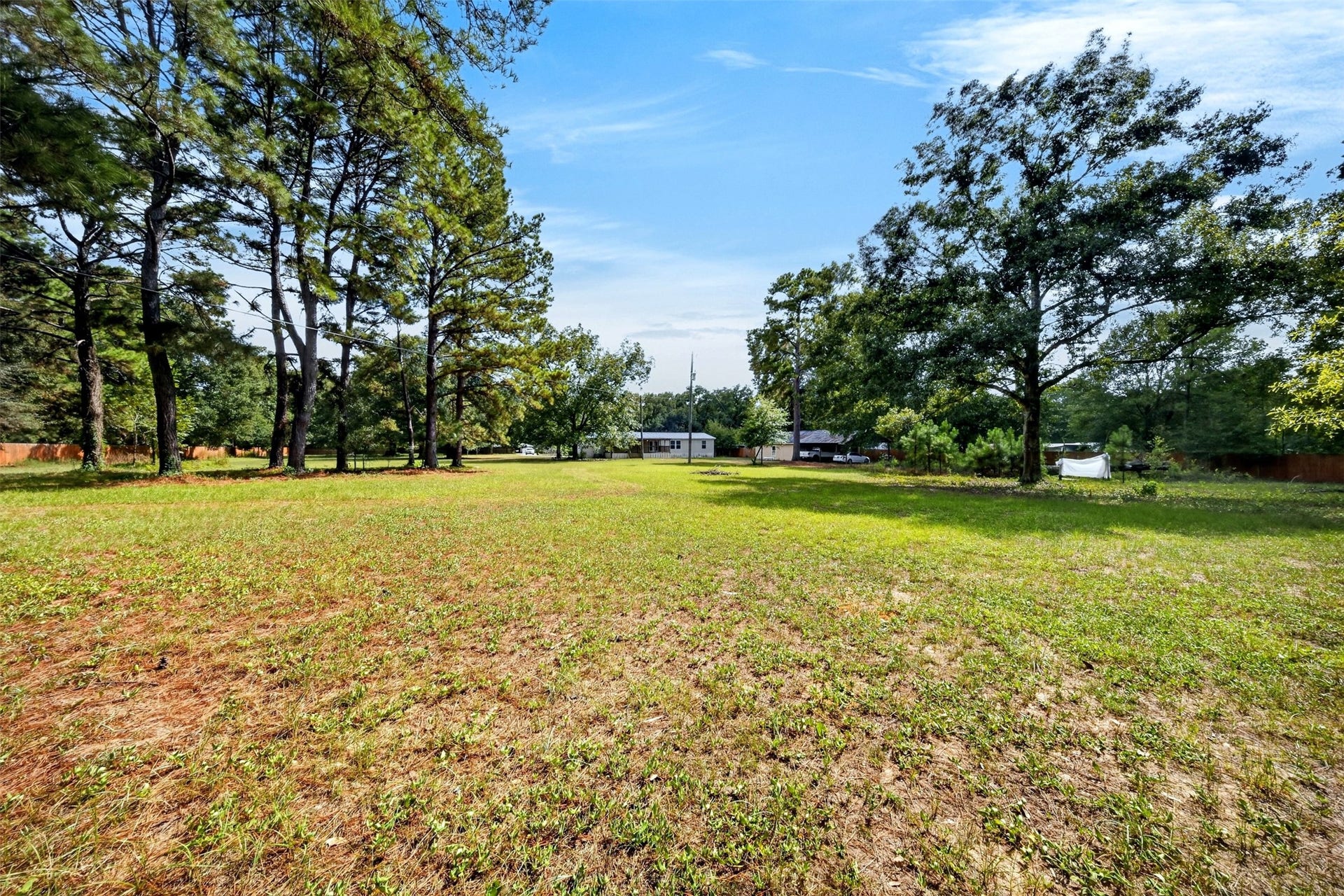 2581 Mann Road, Conroe, TX 77303 Additional view highlighting the propertys generous yard and mature tree coverage.