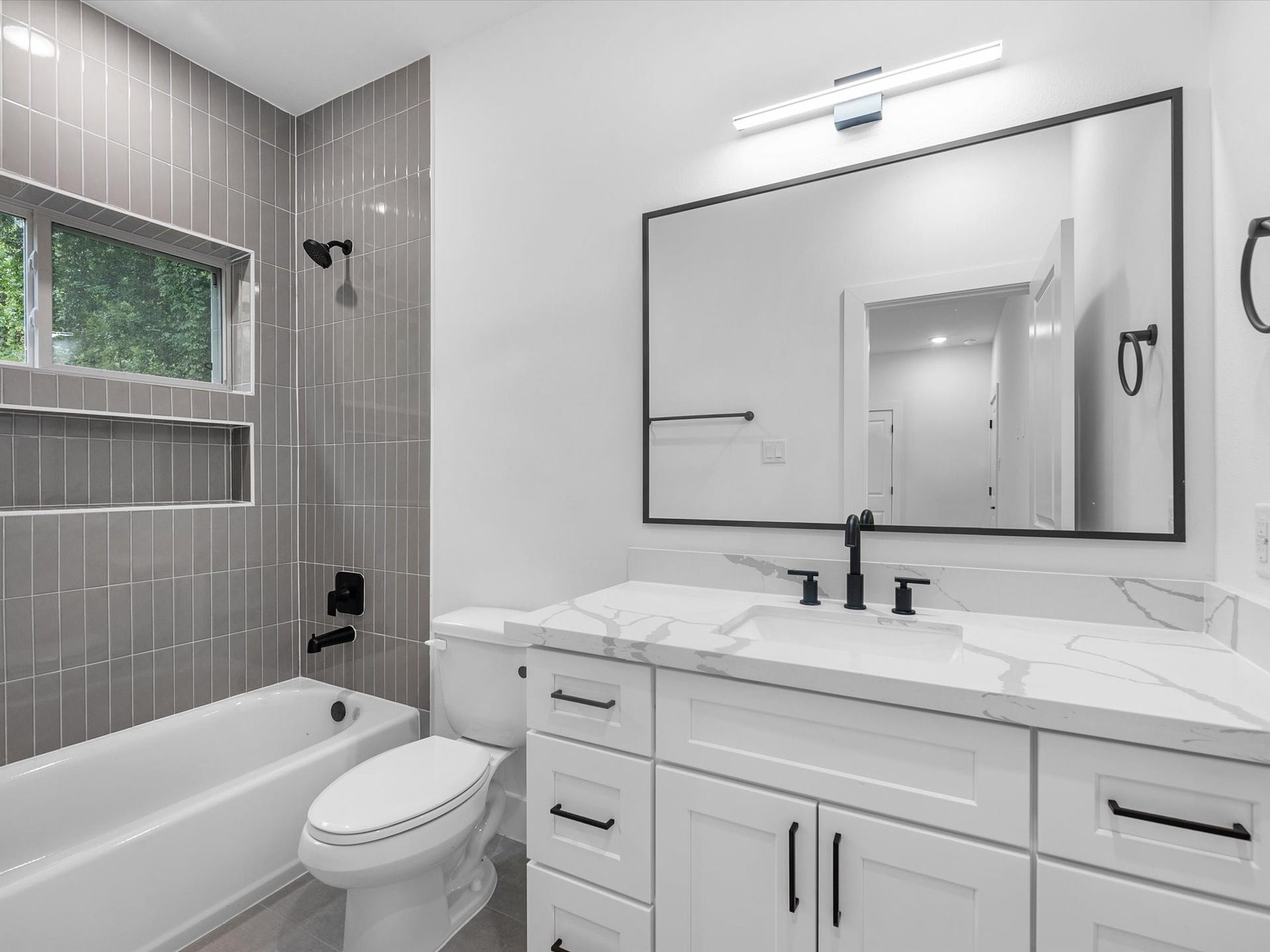 Beautiful first-floor full bathroom conveniently connected to the bedroom, offering privacy and comfort. Each bedroom in the home features its own private full bathroom, providing a functional and comfortable layout for everyone.