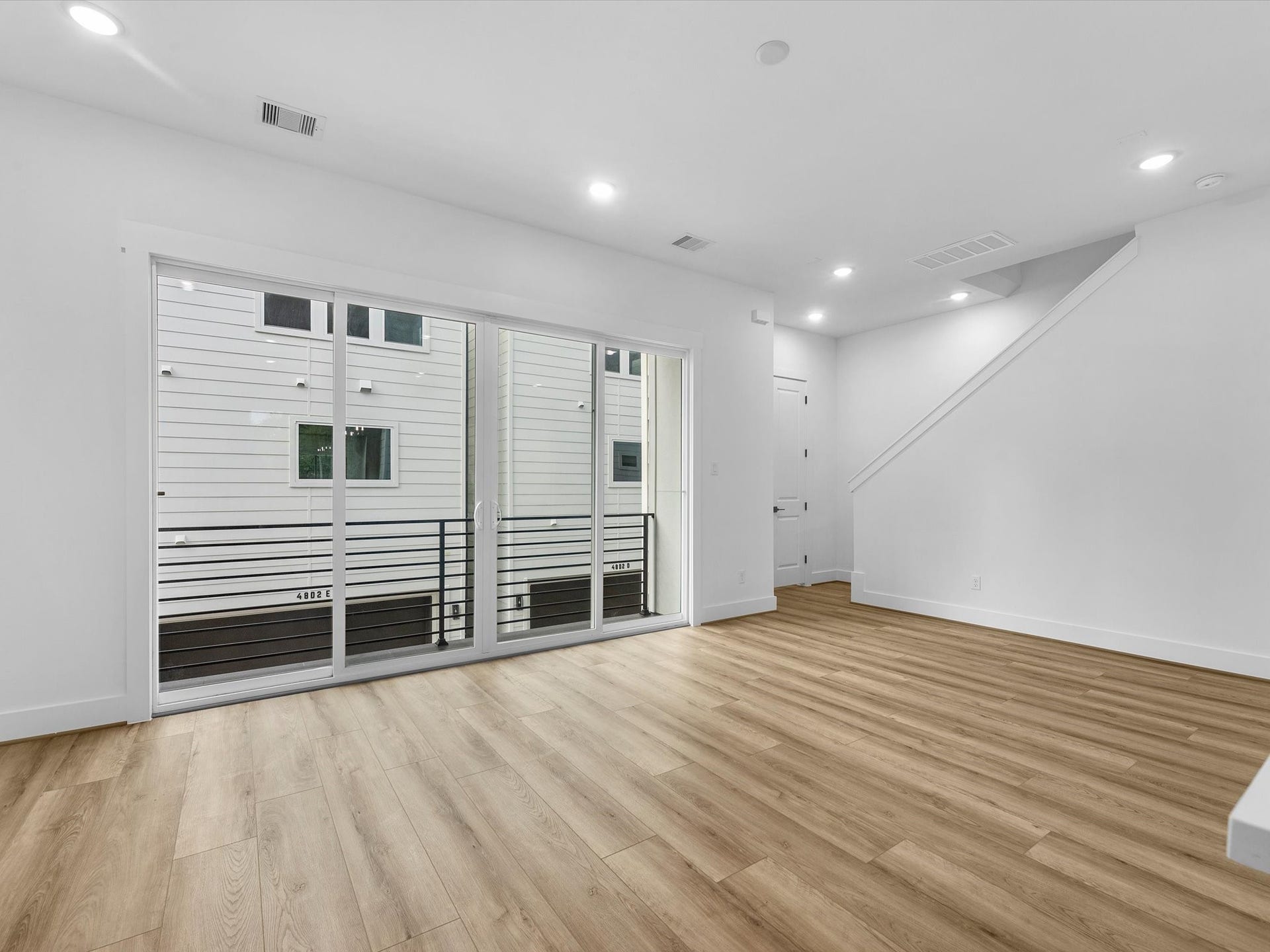 Large sliding glass doors create a seamless indoor-outdoor feel, opening directly to the private balcony. Perfect for bringing in natural light and extending the living space outdoors.
