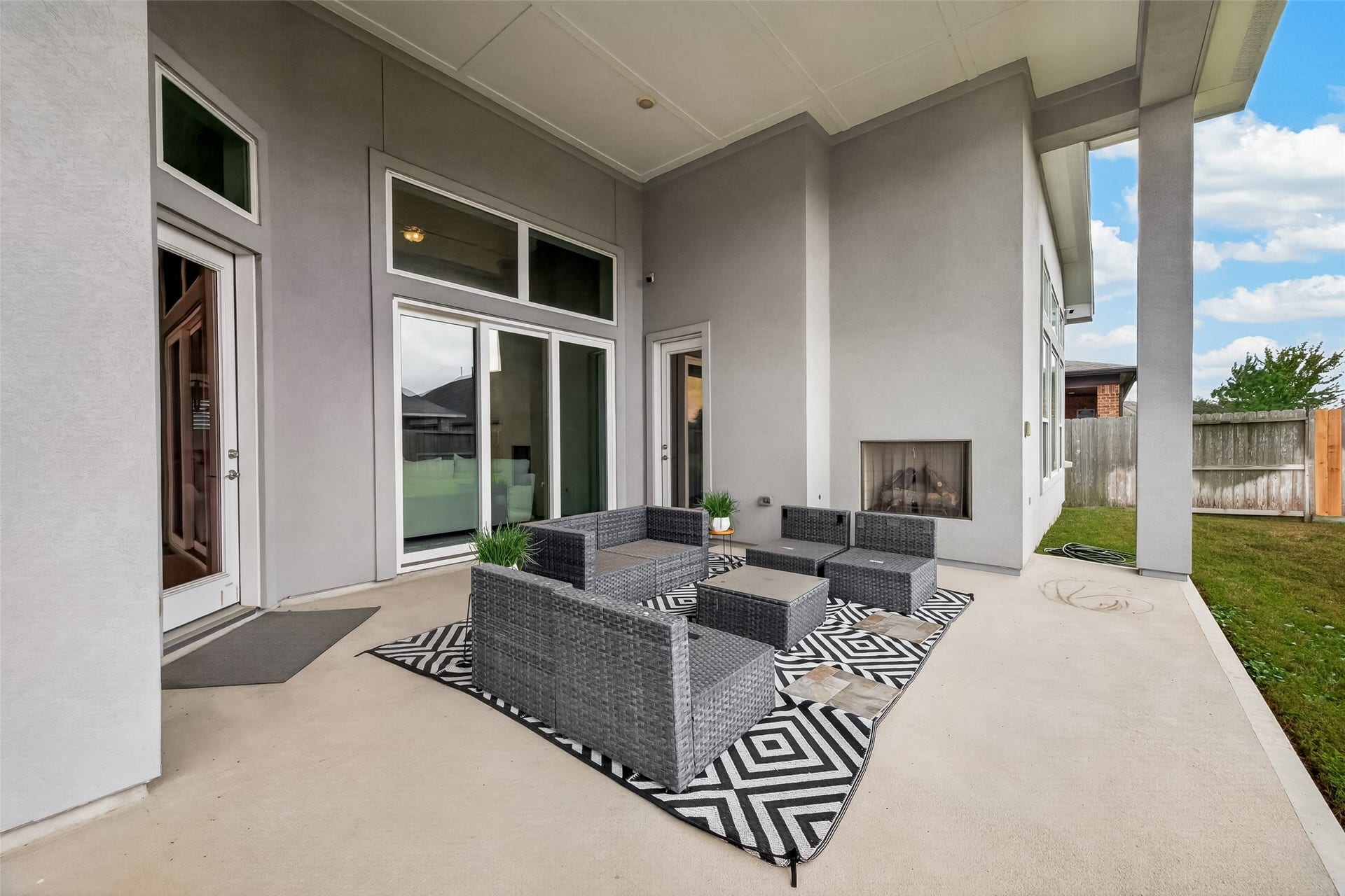 11219 Elm Creek Falls Court, Cypress, TX 77433 Covered patio on the back yard with fireplace and outdoor kitchen.
