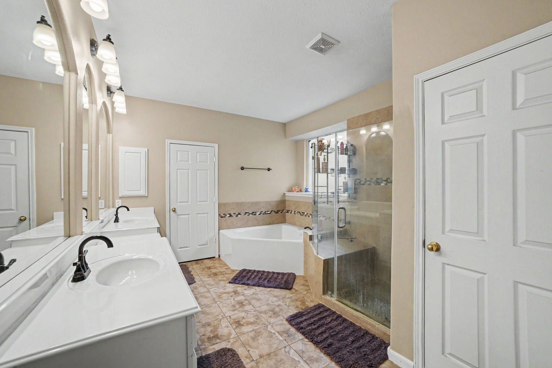 12807 Rocky Briar Lane, Tomball, TX 77377 The primary bathroom features dual sinks, a soaking tub, separate shower, and plenty of vanity storage.