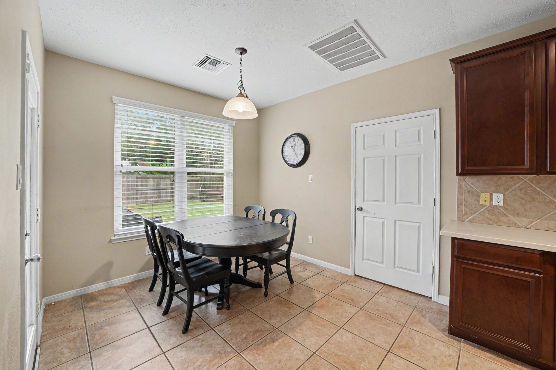 12807 Rocky Briar Lane, Tomball, TX 77377 The breakfast nook offers a welcoming spot for casual dining, with a large window overlooking the backyard and convenient access to the kitchen.
