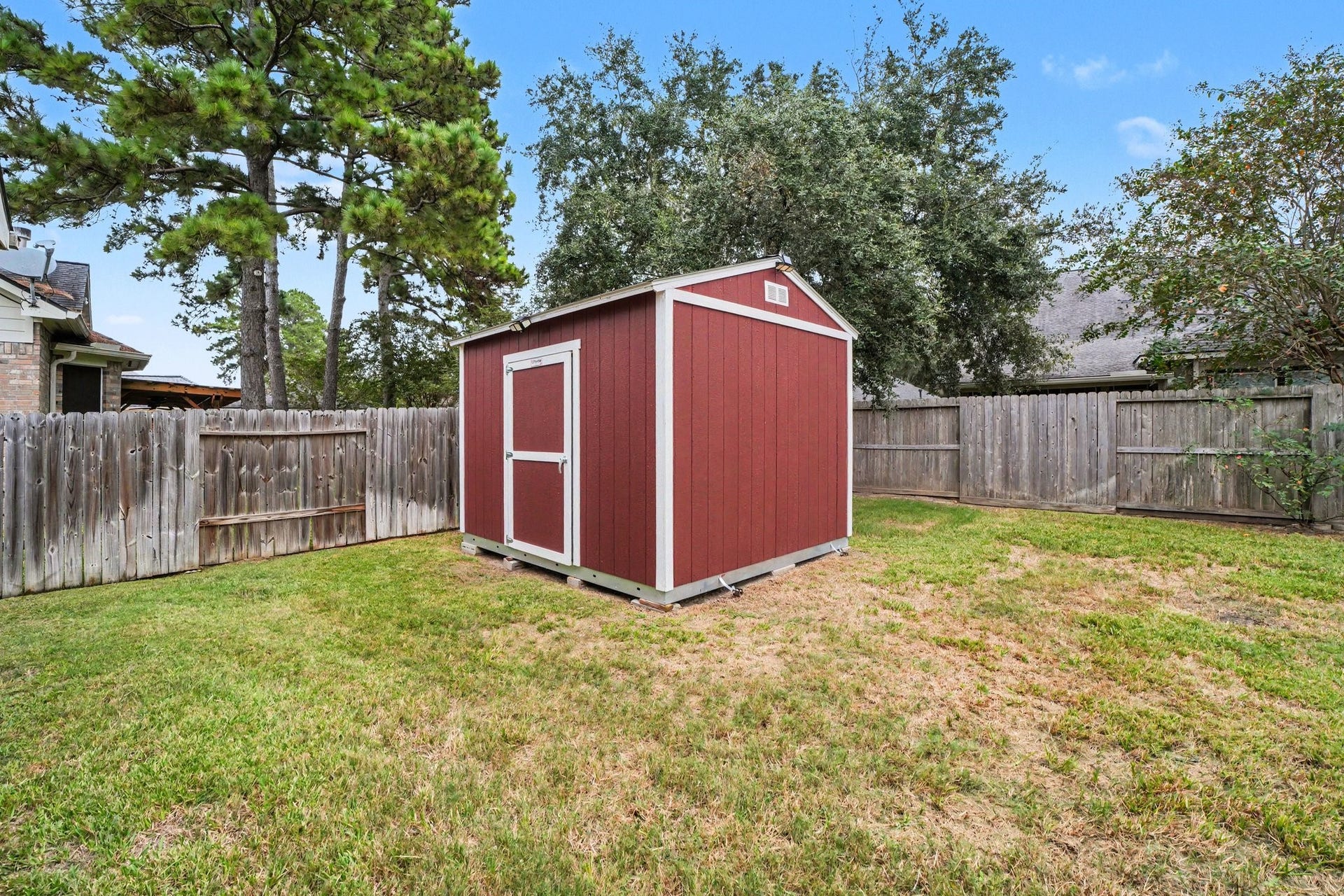 12807 Rocky Briar Lane, Tomball, TX 77377 The backyard features a 1012 Tuff Shed with electricity available, offering additional storage for tools, lawn equipment, and outdoor essentials.
