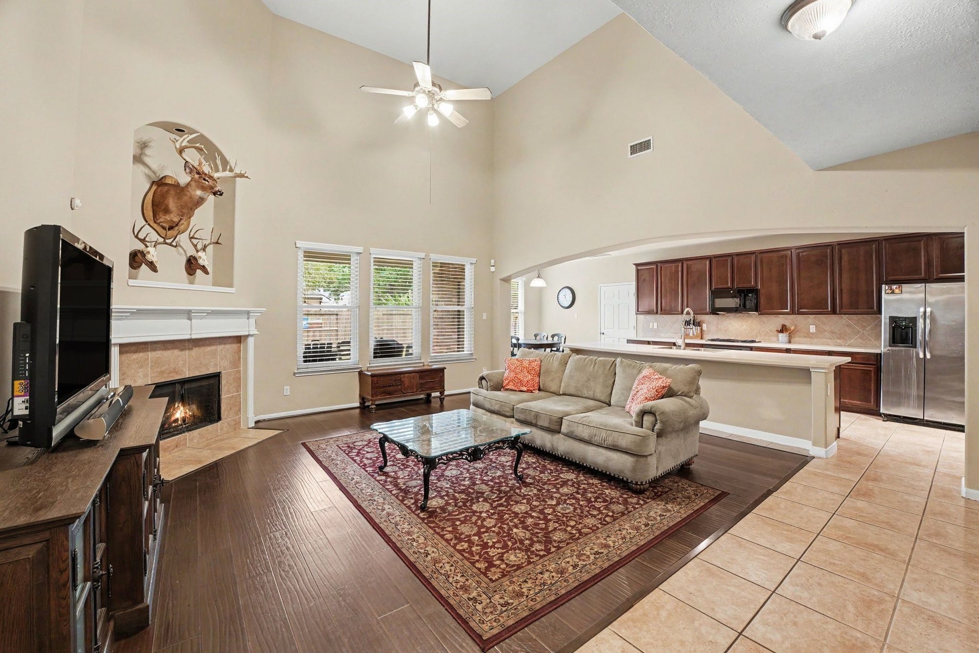 12807 Rocky Briar Lane, Tomball, TX 77377 can you do this one?
Inviting living room featuring soaring ceilings, beautiful wood flooring, and a fireplace that serves as the focal point. The open layout connects seamlessly to the kitchen and breakfast area, creating a wonderful space for everyday living and entertaining.
