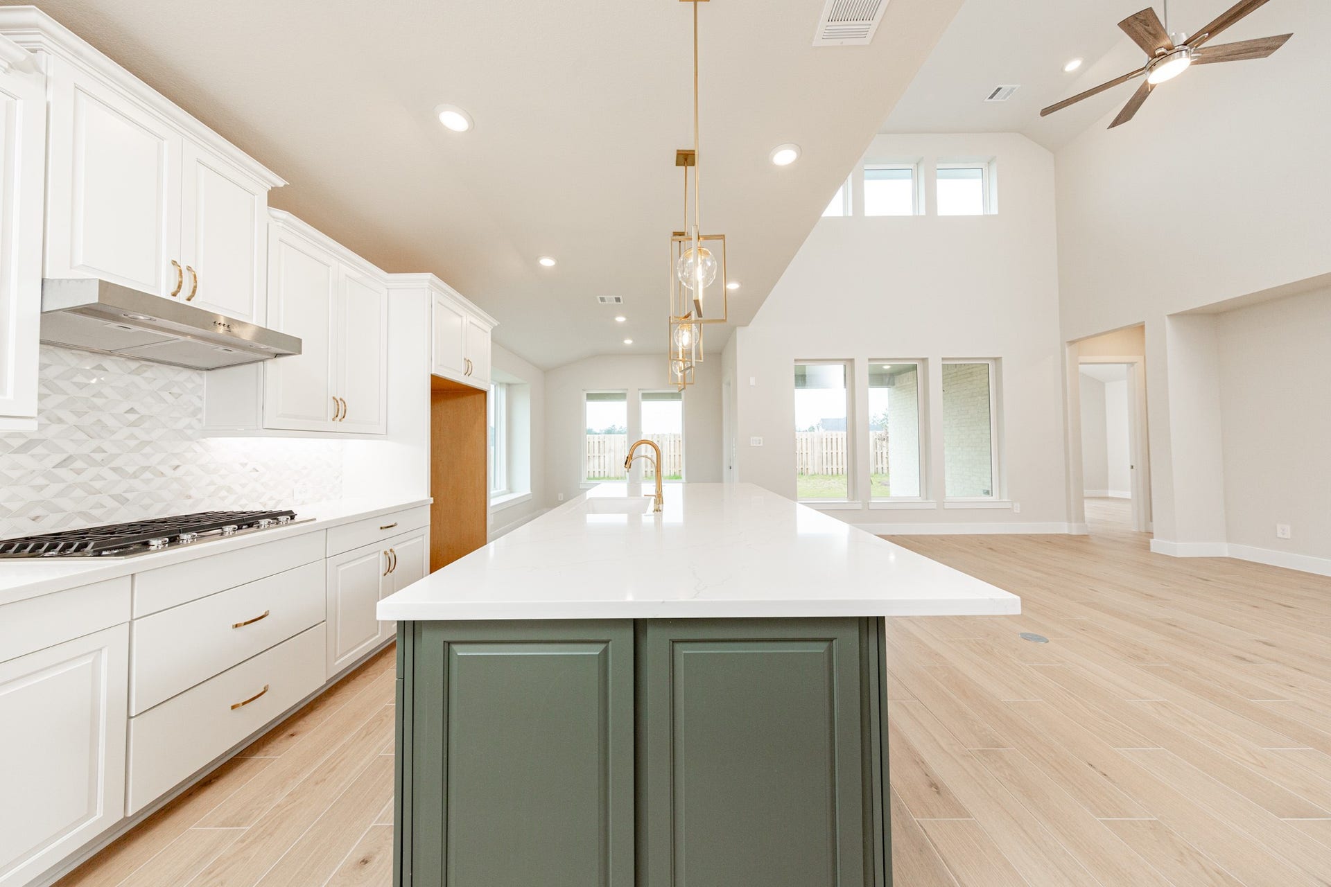The kitchen includes Whirlpool stainless steel appliances: 30" 5-burner gas cooktop, coordinating built-in stainless steel microwave, oven wall unit, and dishwasher suggesting a professional and polished space.
