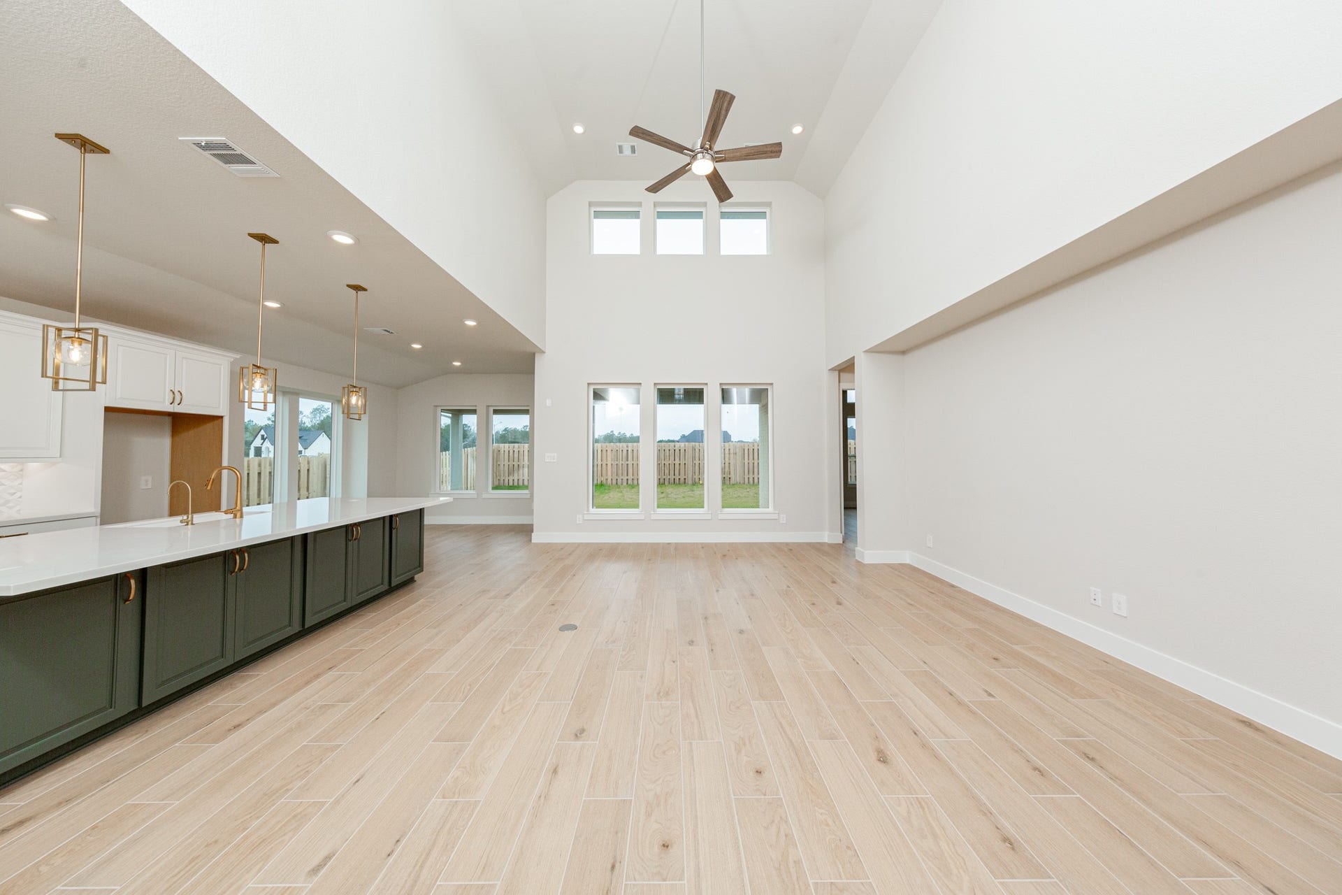 Enjoy an open, airy living experience in the GREAT ROOM where oversized windows flood the entire space with abundant natural light and frame a picturesque view of the serene backyard. A large ceiling fan provides comfort all year long. The integrated wall niche offers valuable recessed storage and display space without encroaching on the room's floor plan.