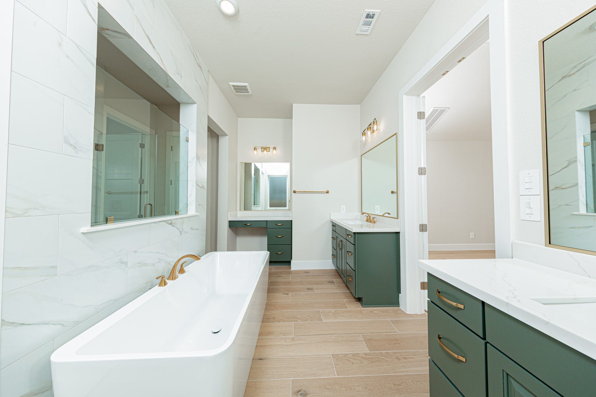 Additional view of dual vanities which also includes another vanity with knee space, allowing for a comfortable, seated grooming experience.