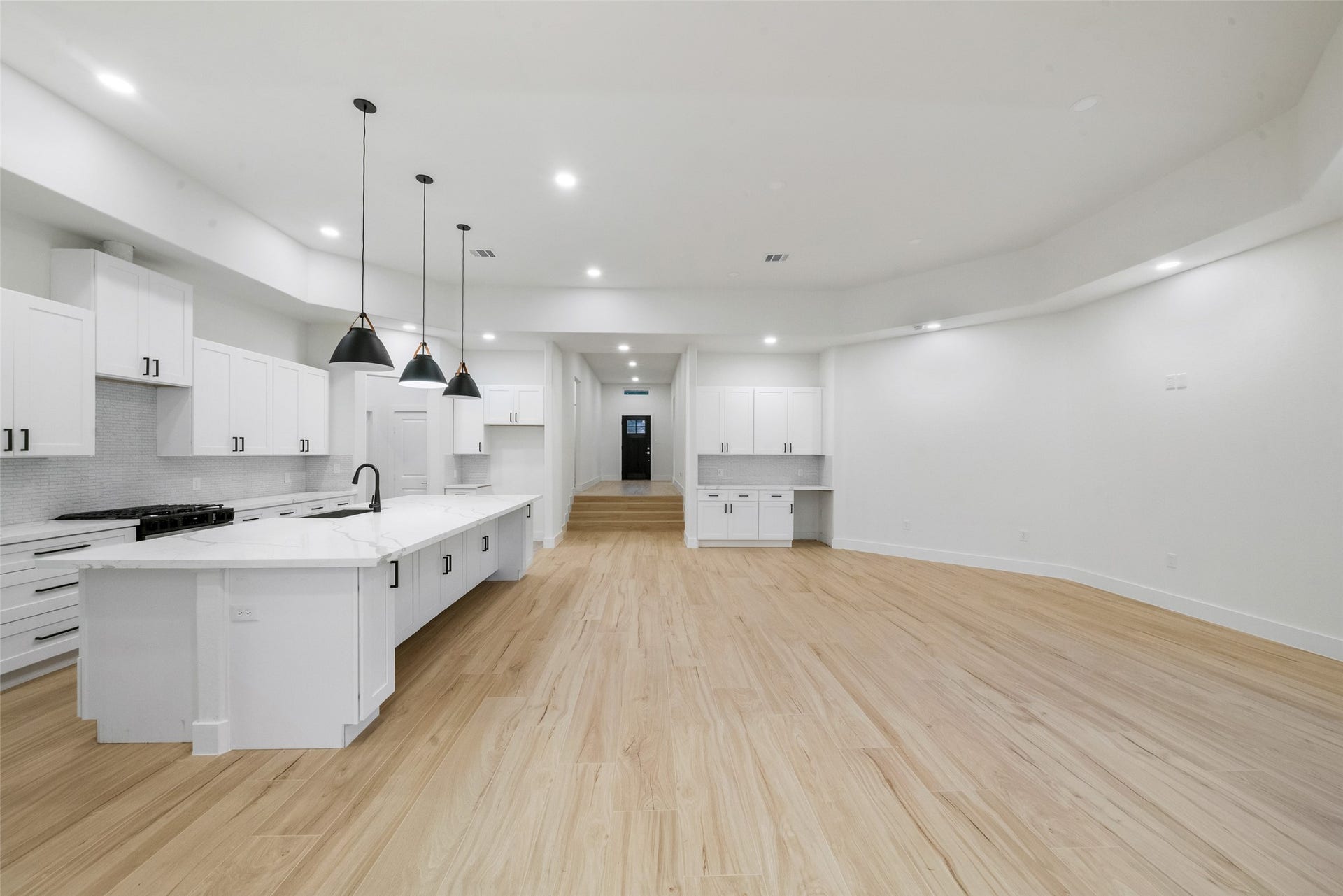 4833 W Fork Boulevard, Conroe, TX 77304 Impressive open-concept design seamlessly connects the gourmet kitchen and expansive living area. Beautiful wood-look flooring, recessed lighting, and elegant architectural details create an inviting atmosphere ideal for entertaining.
