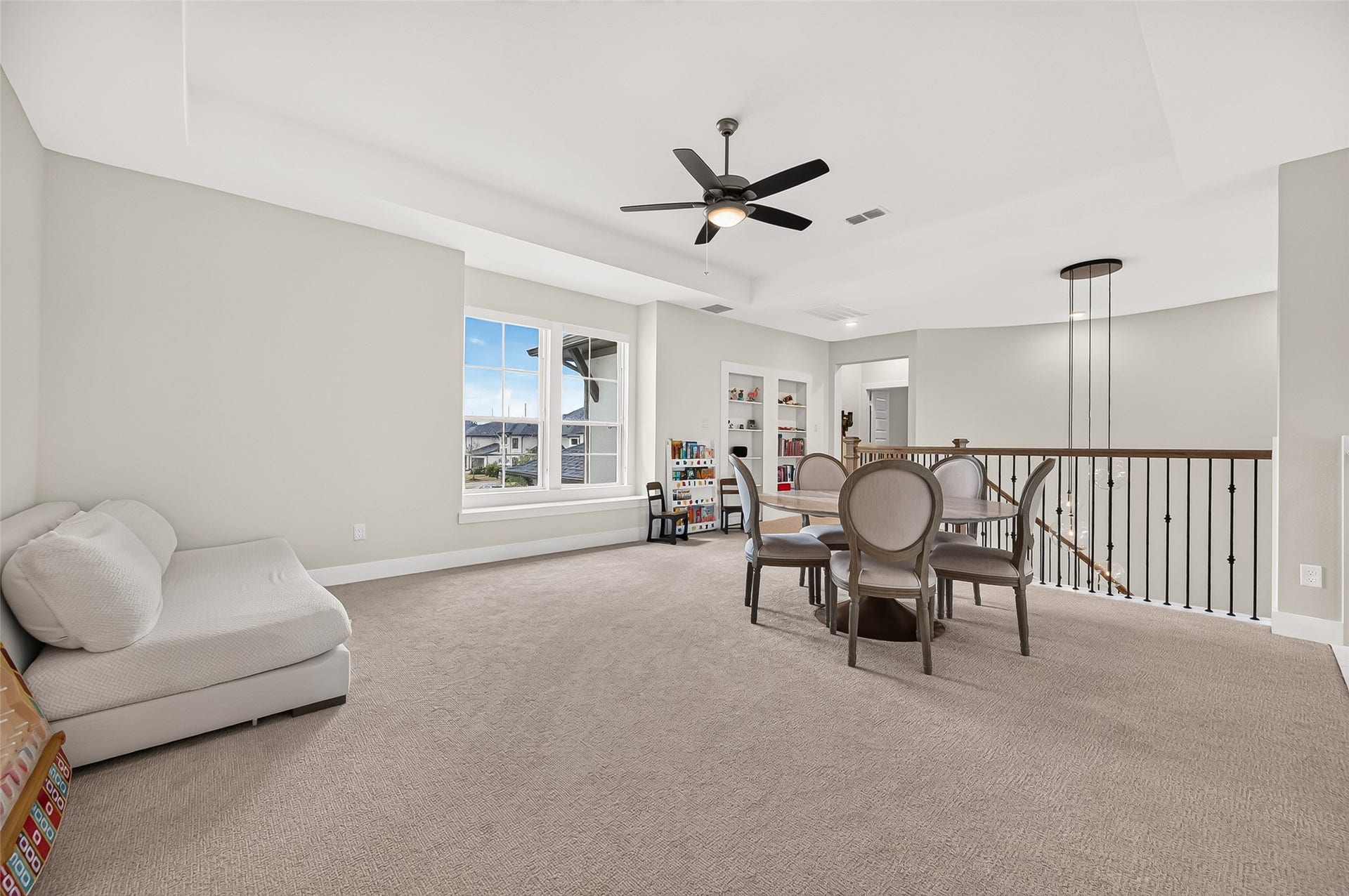 2710 Berry Basket Trail, Richmond, TX 77406 Upstairs, the spacious game room features built-in bookshelves and a hidden/secret opening leading to additional storage.