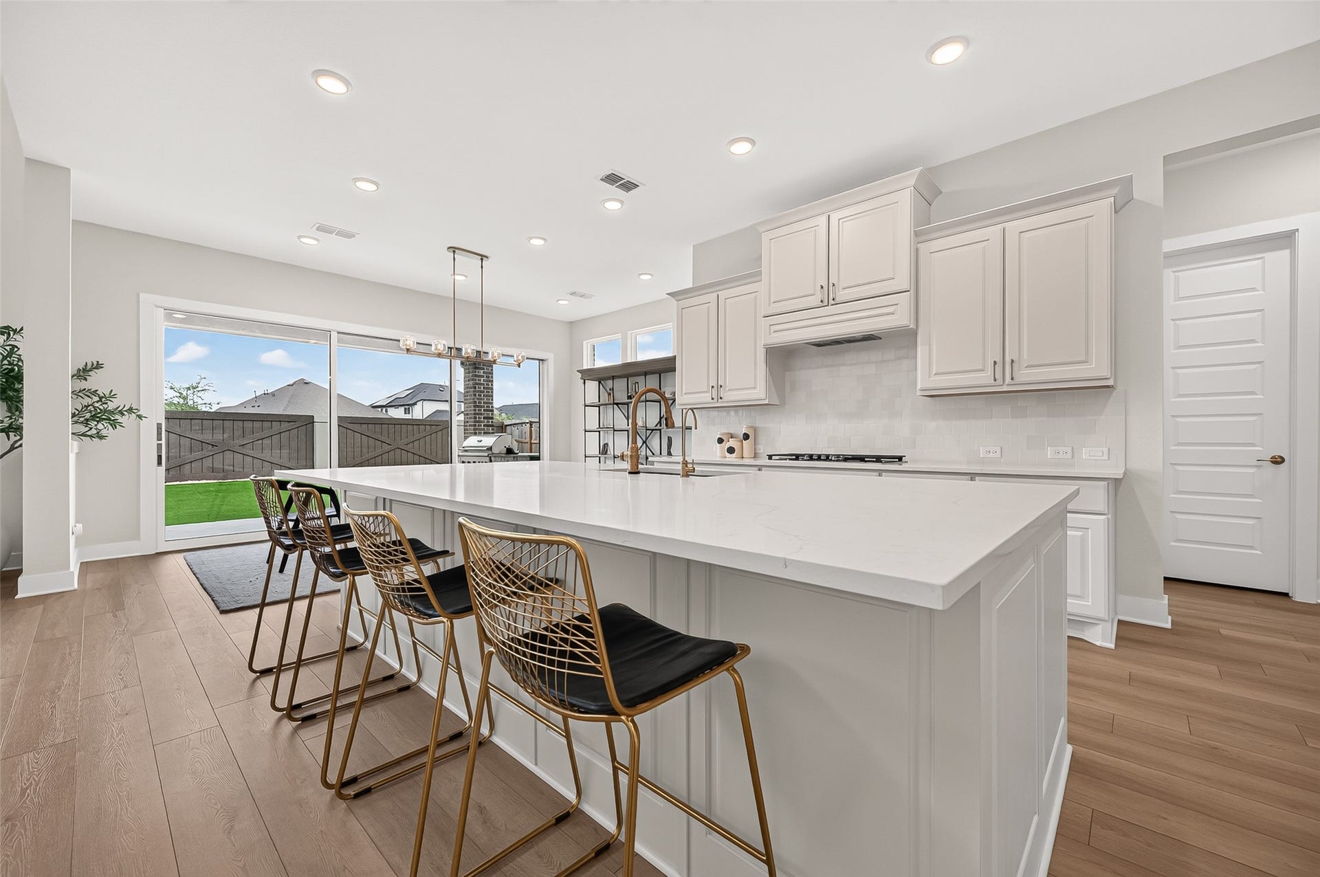 2710 Berry Basket Trail, Richmond, TX 77406 The chefs kitchen is the centerpiece of the home, featuring a massive island with manufactured stone countertops, built-in stainless-steel appliances, gas range, beautiful cabinetry with hardware, and a sink equipped with reverse osmosis.