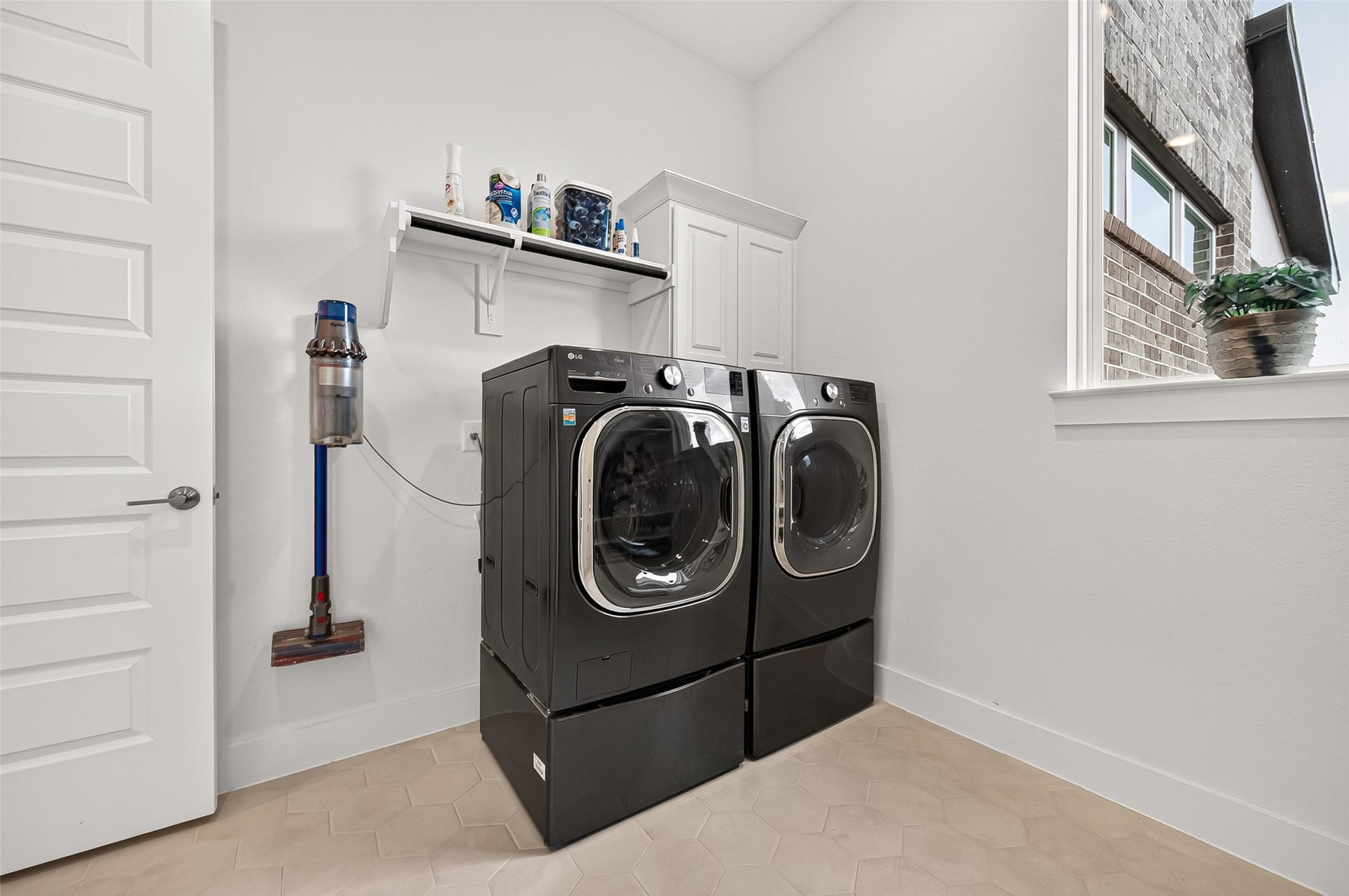 2710 Berry Basket Trail, Richmond, TX 77406 A large laundry room offers built-in cabinetry, hanging racks, and a convenient mud-drop area.
