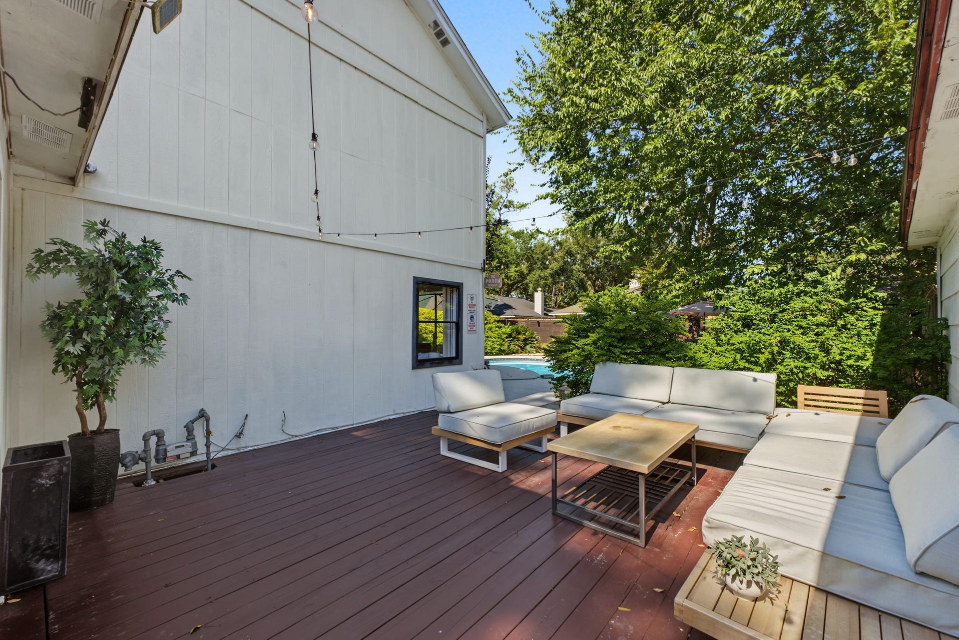 5006 Deer Point Drive, Spring, TX 77389 Expansive wood deck under string lights is made for entertaining poolside!