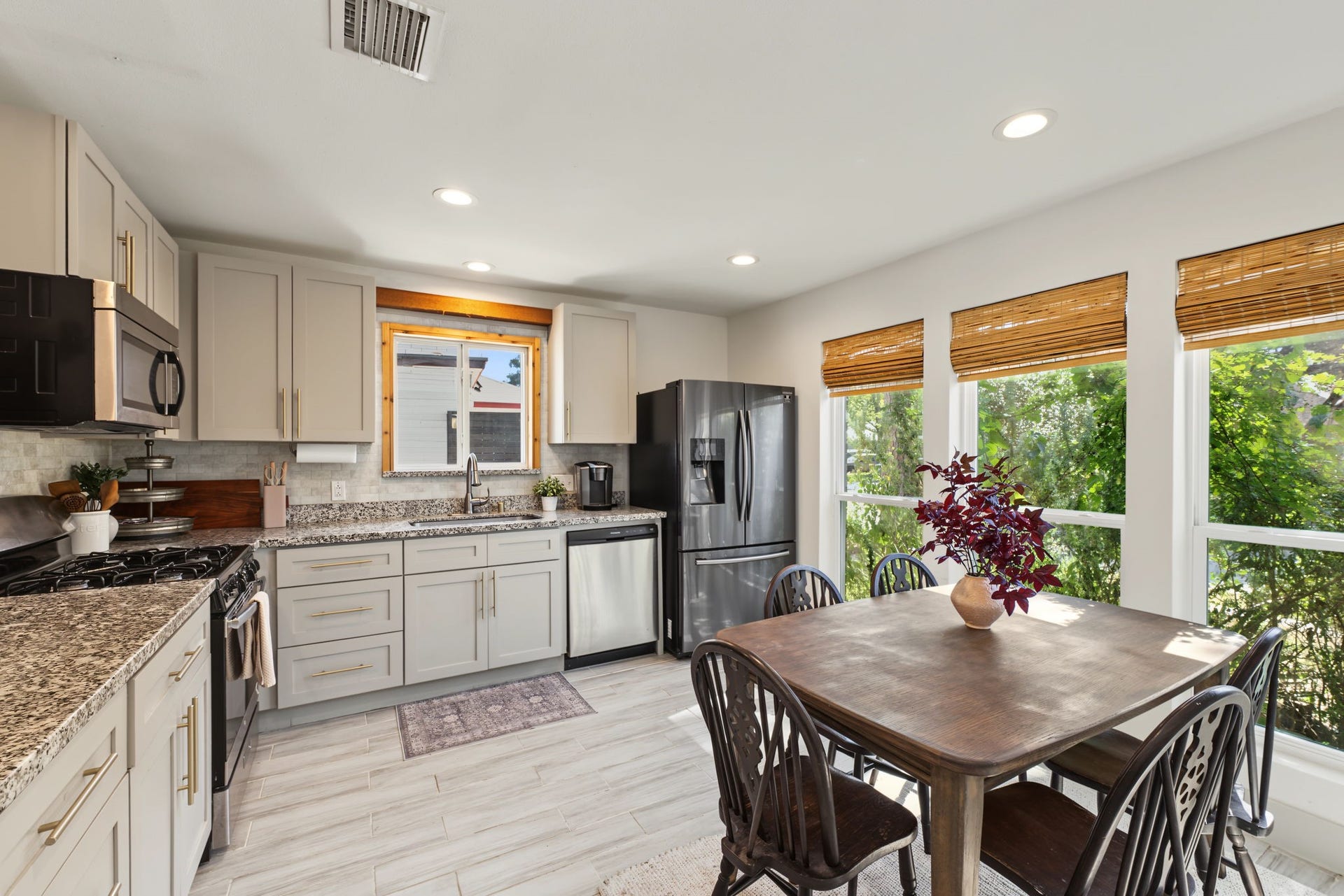 5006 Deer Point Drive, Spring, TX 77389 Remodeled kitchen features shaker cabinets with gold hardware, granite countertops, marble-look mosaic backsplash and stainless appliances including a gas range!