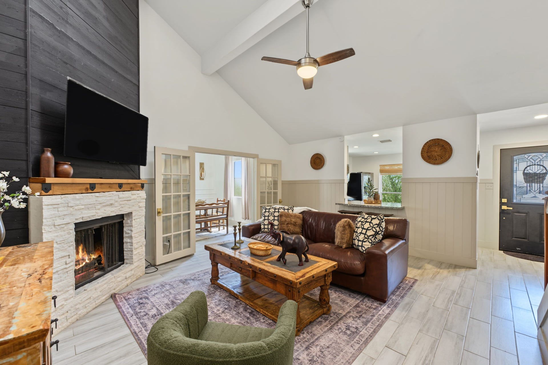 5006 Deer Point Drive, Spring, TX 77389 Cozy up by the fireplace! French doors lead to the flex room, and shiplap wainscoting adds charm throughout.